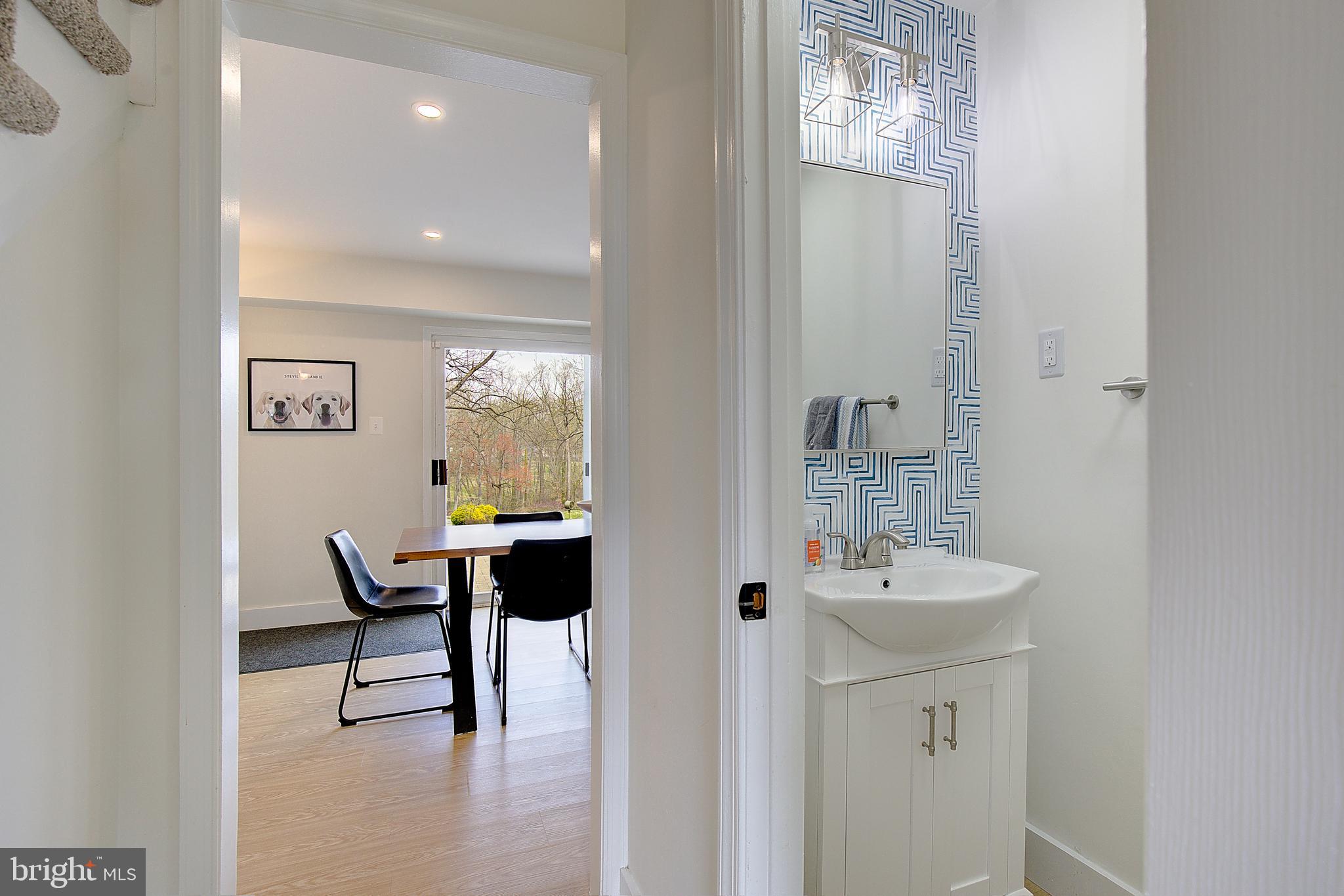 1702 Saxony Place Crofton, MD 21114 - Photo 10 of 65 a bathroom with a sink and a mirror