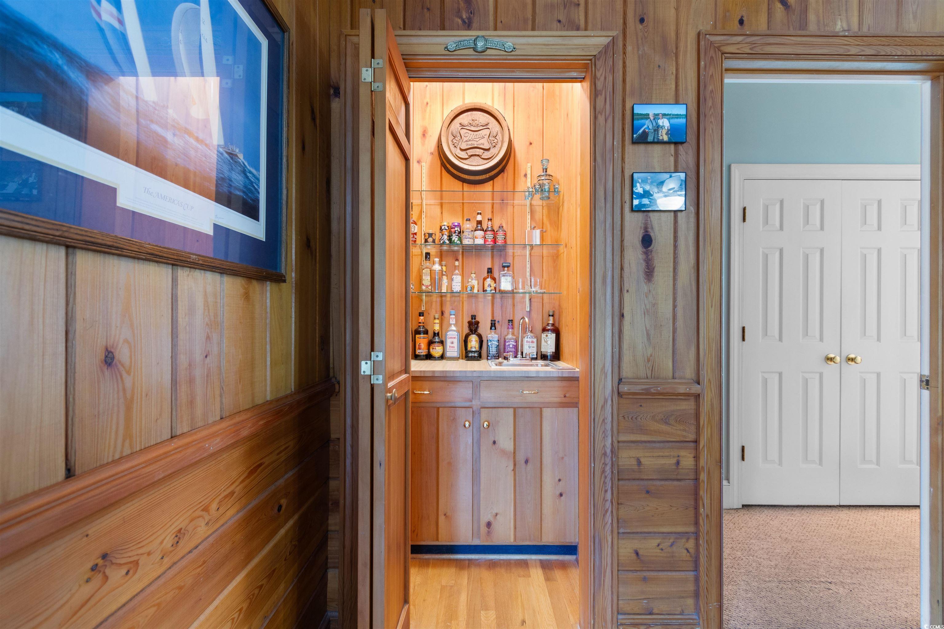 14 Live Oak Lane Georgetown, SC 29440 - Photo 12 of 40 Bar with wooden walls and original hardwod floors.