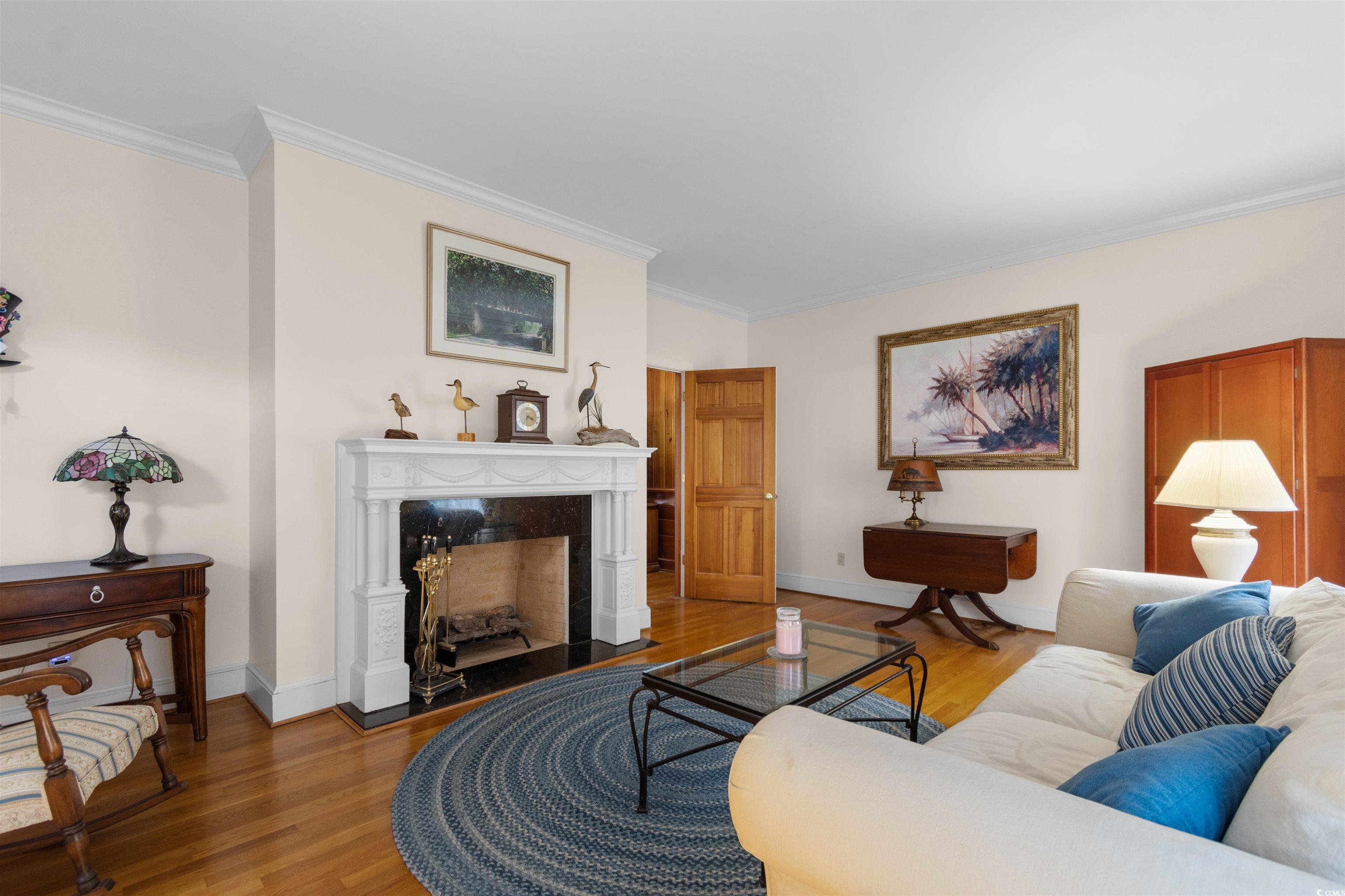 14 Live Oak Lane Georgetown, SC 29440 - Photo 14 of 40 Living area featuring ornamental molding, original hardwood flooring, and a premium fireplace