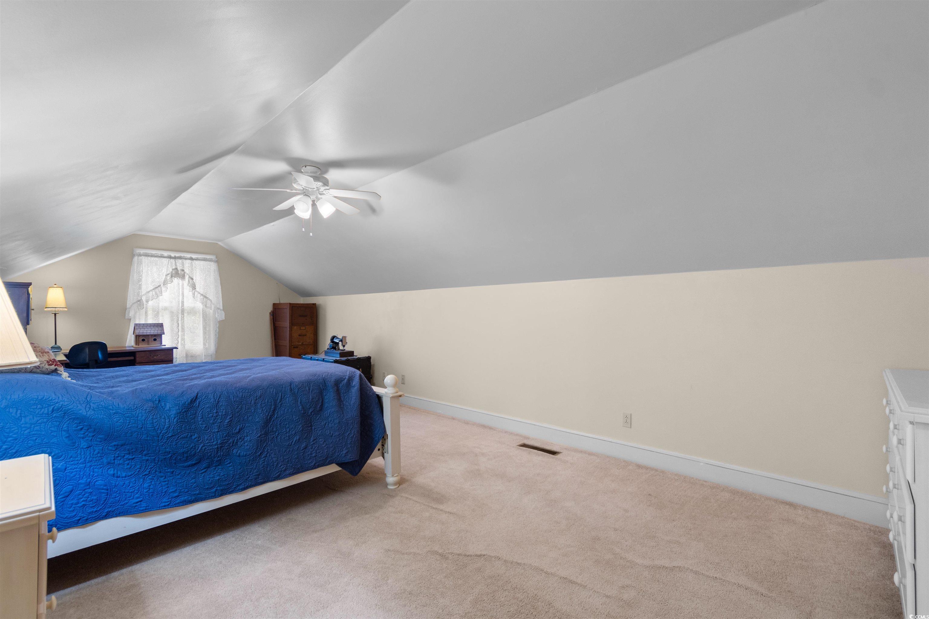 14 Live Oak Lane Georgetown, SC 29440 - Photo 22 of 40 Carpeted bedroom with lofted ceiling and ceiling fan