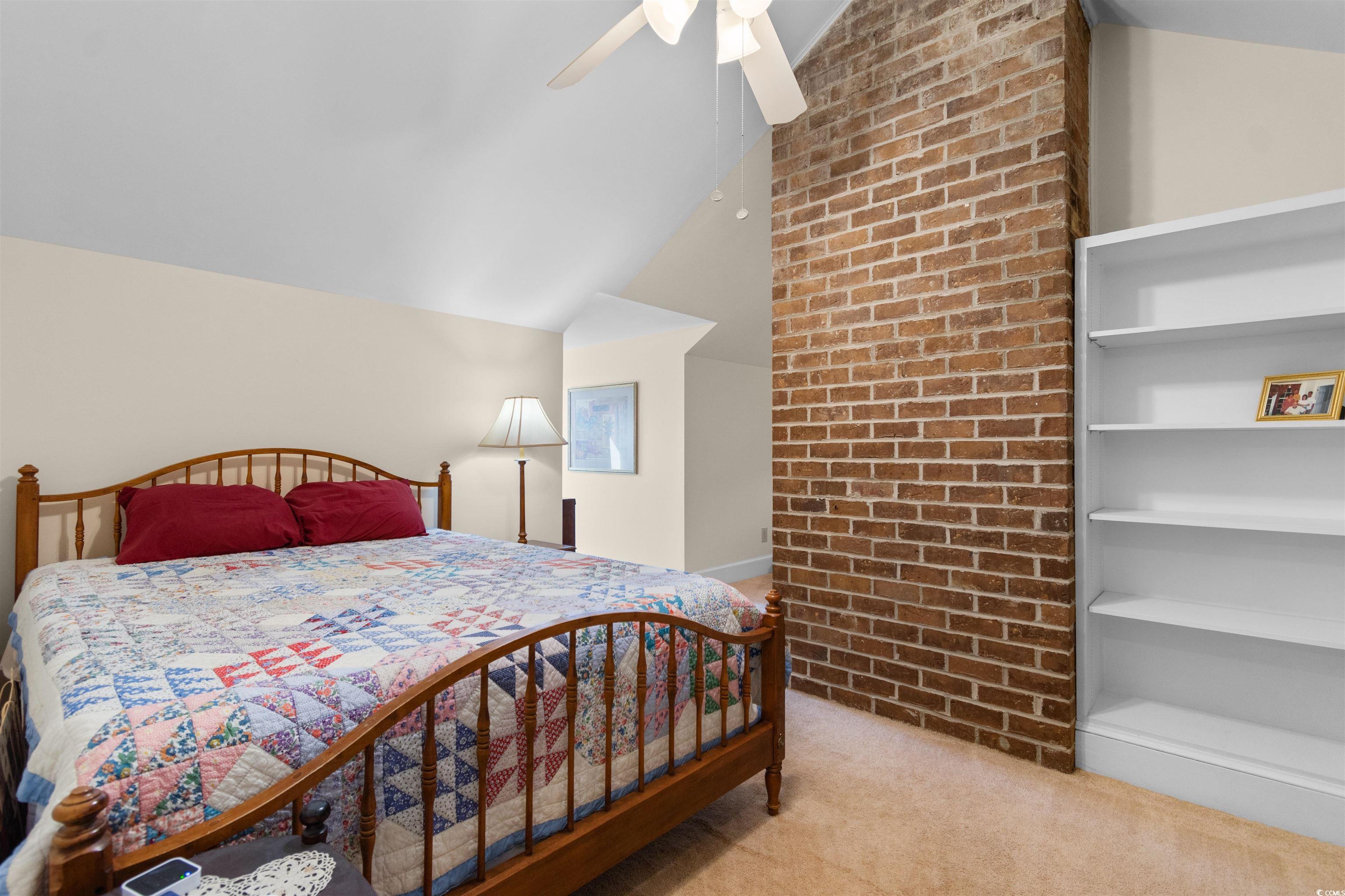 14 Live Oak Lane Georgetown, SC 29440 - Photo 24 of 40 Bedroom featuring vaulted ceiling, light colored carpet, a ceiling fan, and brick wall