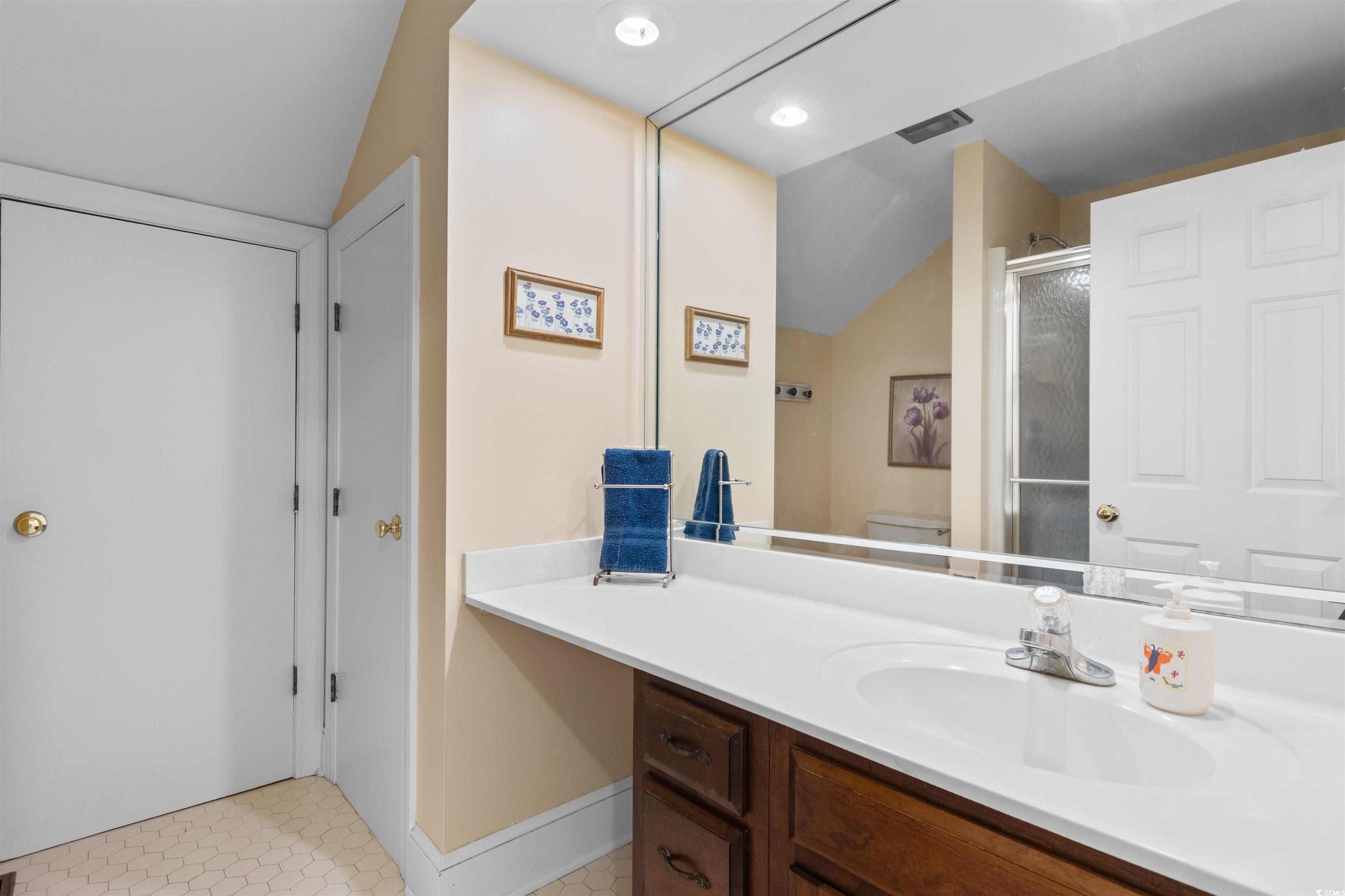 14 Live Oak Lane Georgetown, SC 29440 - Photo 26 of 40 Full bathroom featuring vanity, a shower stall, vaulted ceiling, recessed lighting, and light tile patterned floors