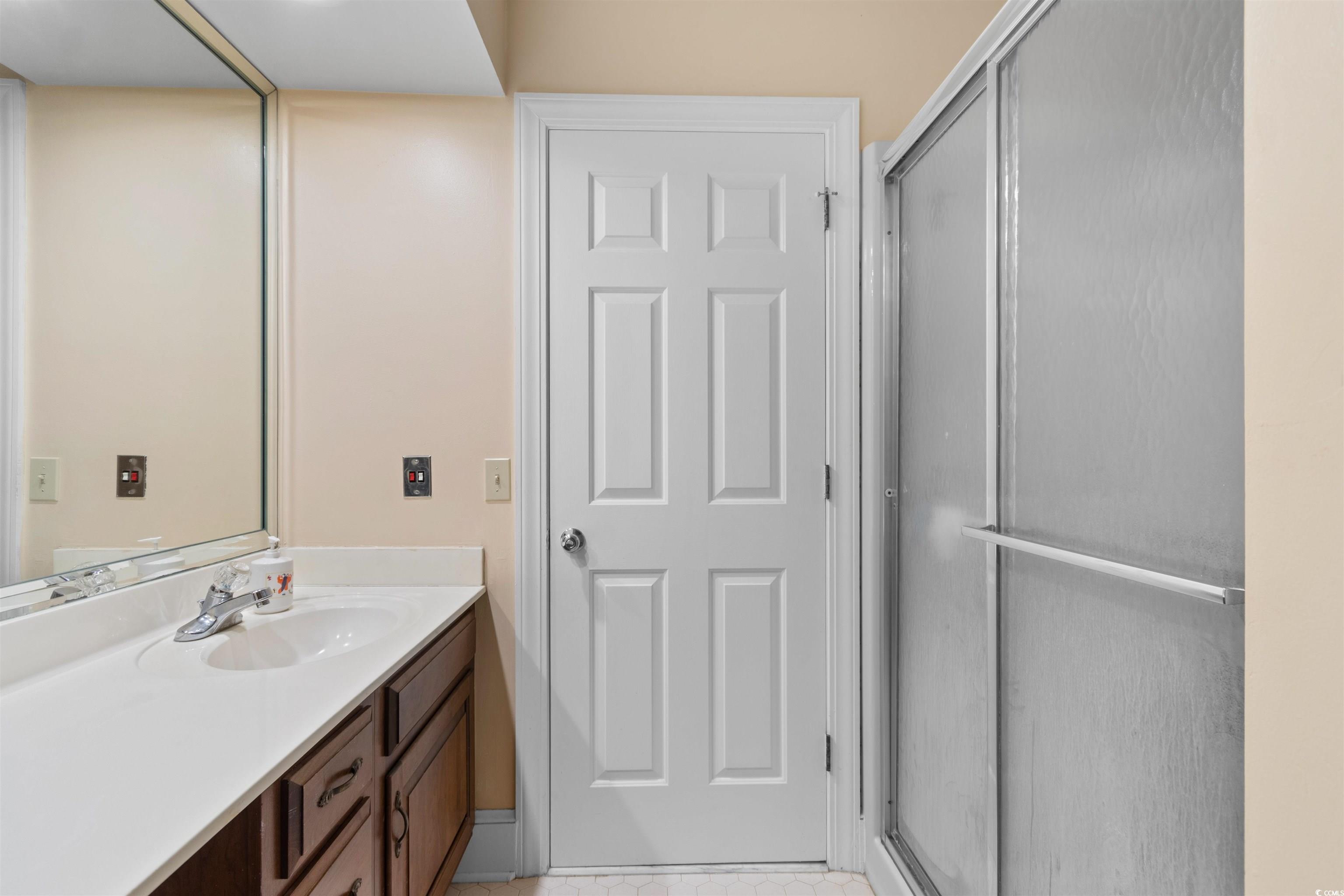 14 Live Oak Lane Georgetown, SC 29440 - Photo 27 of 40 Bathroom featuring vanity, a shower stall, and light tile patterned floors