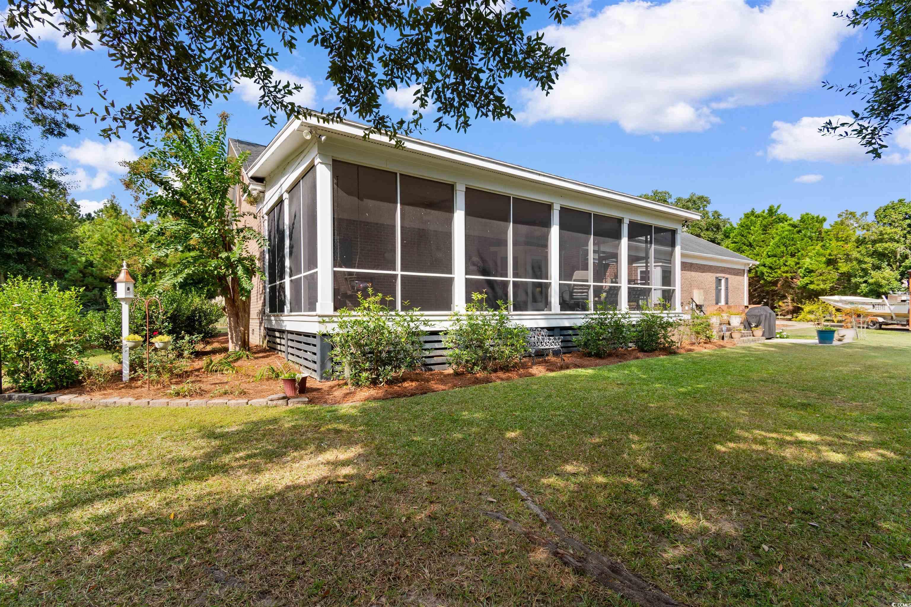 14 Live Oak Lane Georgetown, SC 29440 - Photo 31 of 40 Back of house featuring a lawn and a sunroom