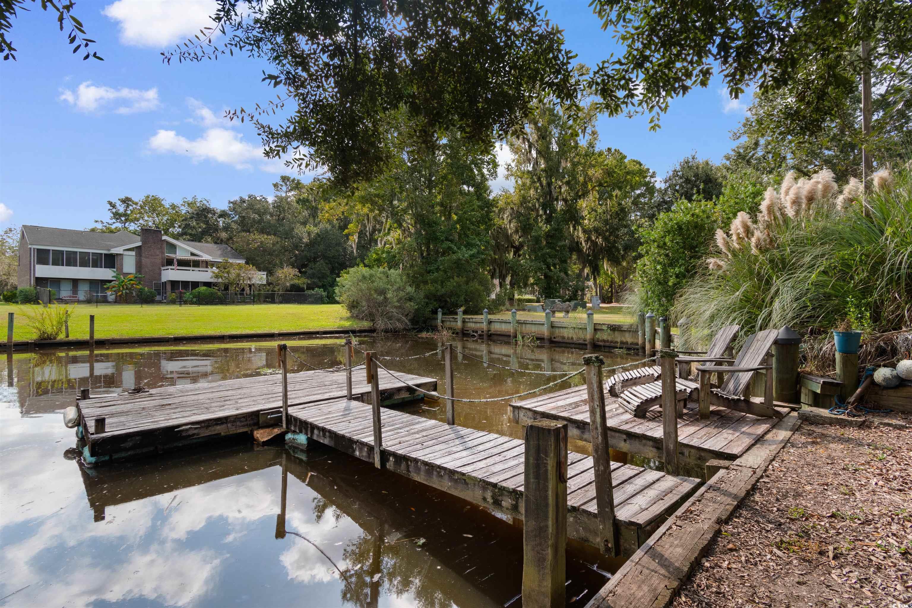14 Live Oak Lane Georgetown, SC 29440 - Photo 34 of 40 Dock featuring a water view, view of wooded area, and a yard