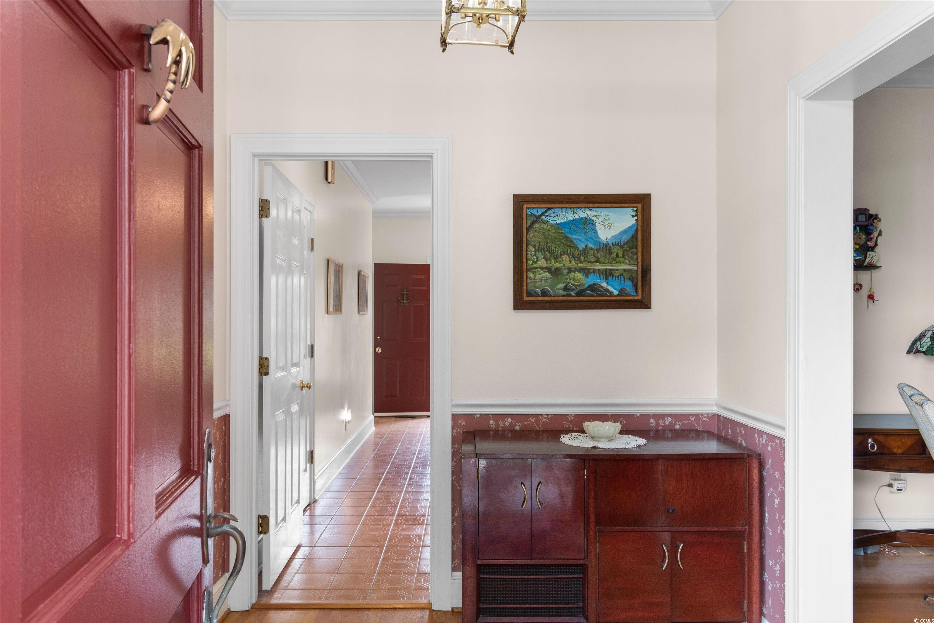 14 Live Oak Lane Georgetown, SC 29440 - Photo 4 of 40 Hallway with ornamental molding, light wood-style floors, and wainscoting