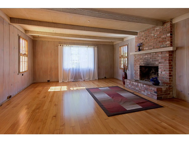 0 Carpenter Street Carmel, CA 93923 - Photo 4 of 20 a view of an empty room with wooden floor fireplace and a window
