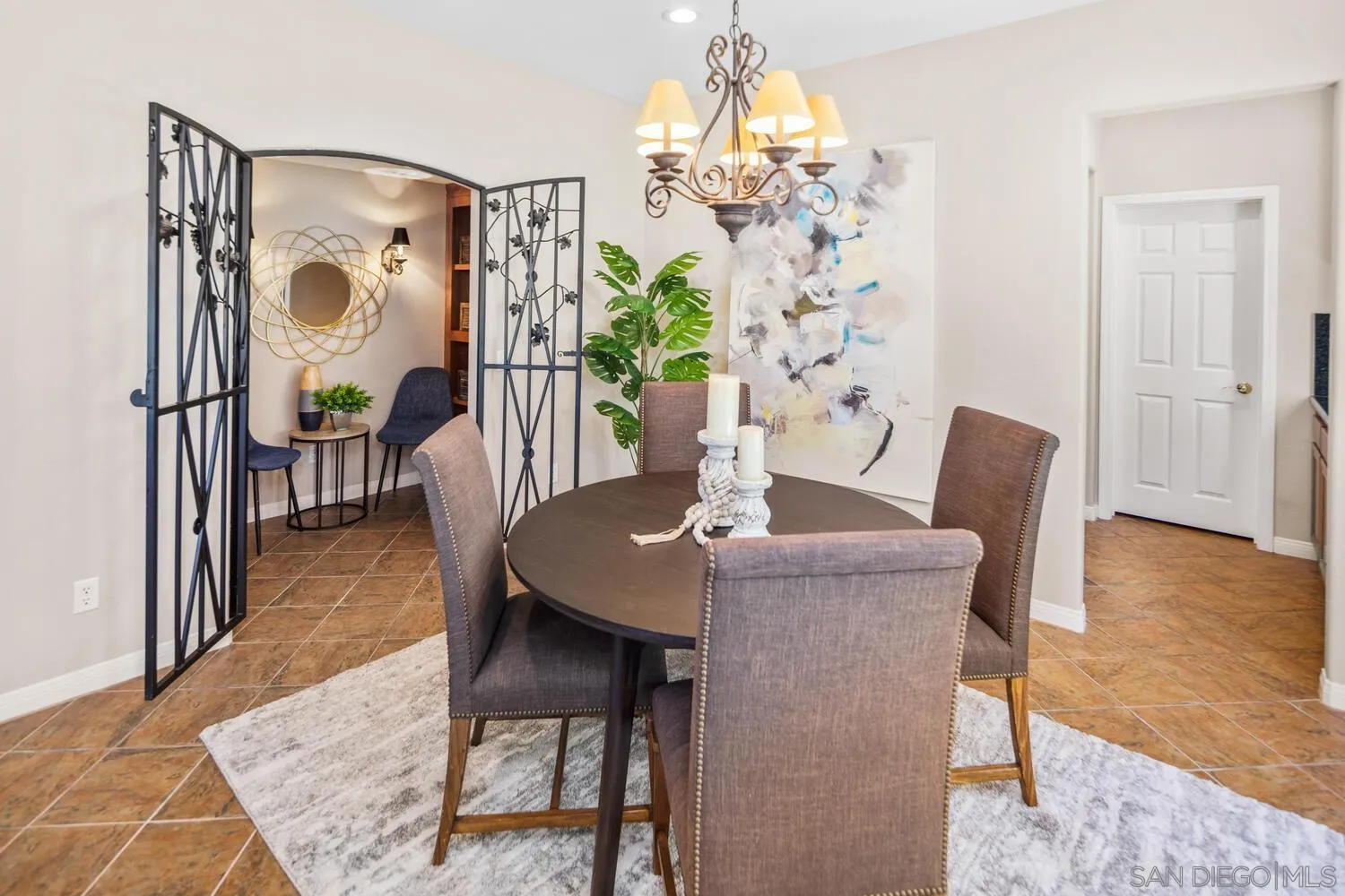 16327 Pinto Ridge Drive 4S Ranch, CA 92127 - Photo 12 of 74 a view of a dining room with furniture wooden floor and chandelier