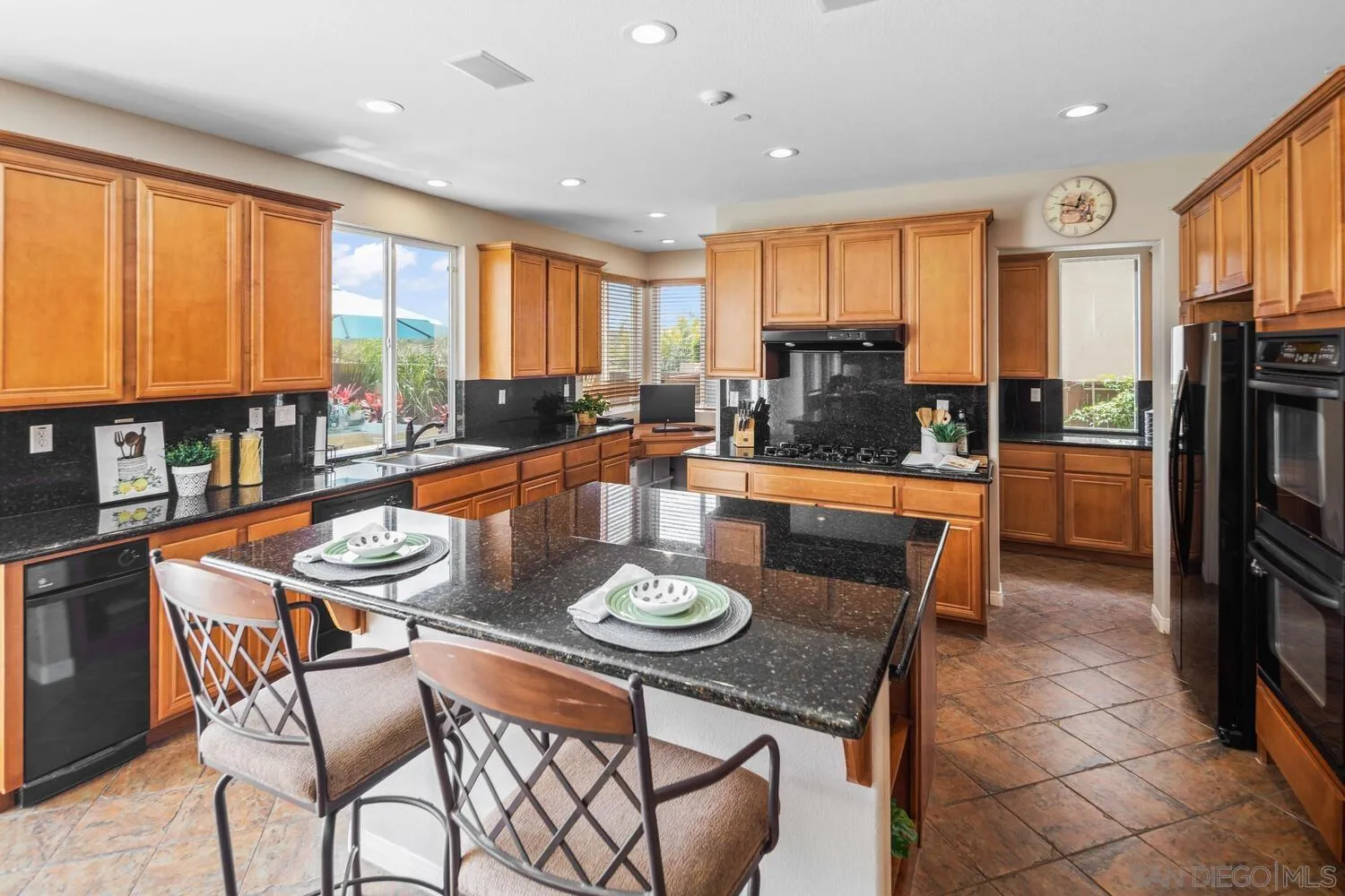 16327 Pinto Ridge Drive 4S Ranch, CA 92127 - Photo 18 of 74 a living room with stainless steel appliances granite countertop furniture a fireplace and a large window