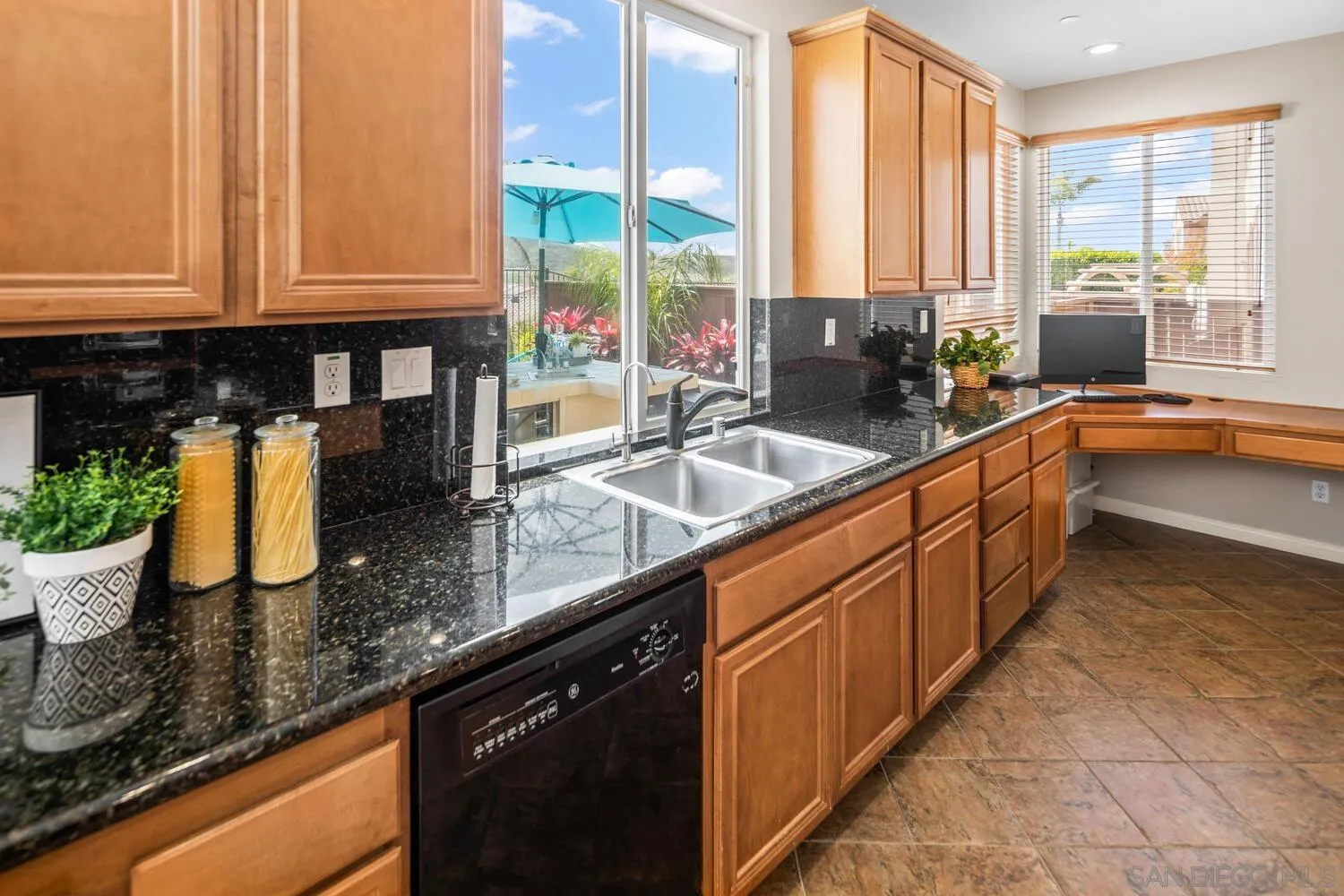 16327 Pinto Ridge Drive 4S Ranch, CA 92127 - Photo 19 of 74 a kitchen with stainless steel appliances granite countertop a sink a counter and a sink