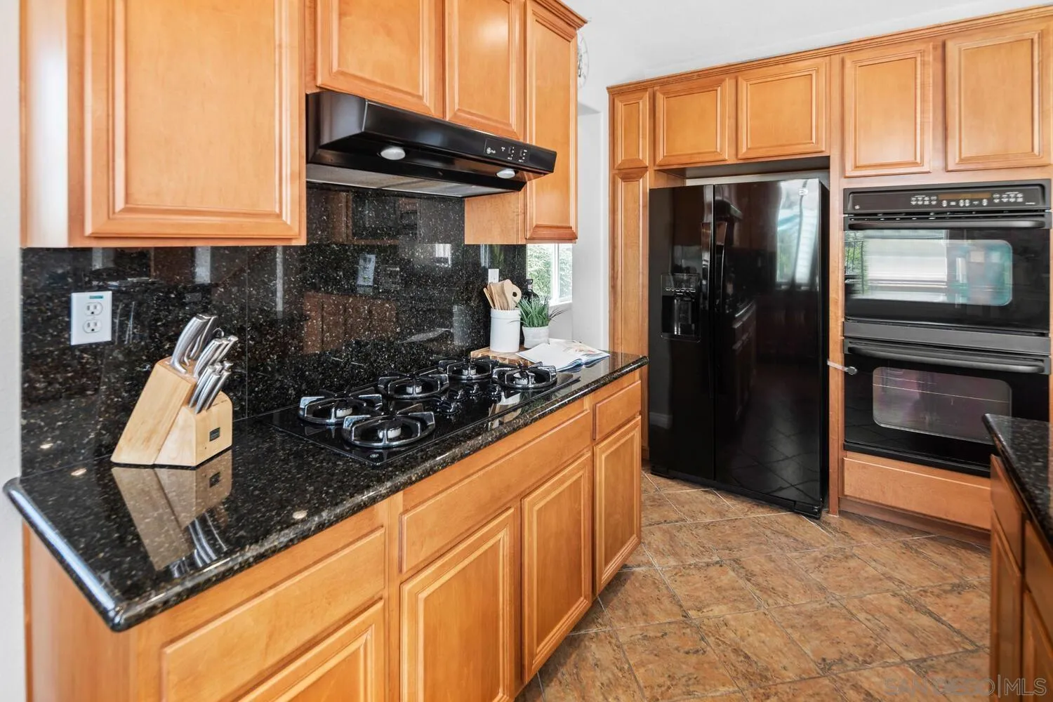 16327 Pinto Ridge Drive 4S Ranch, CA 92127 - Photo 20 of 74 a kitchen with stainless steel appliances granite countertop a refrigerator and a stove