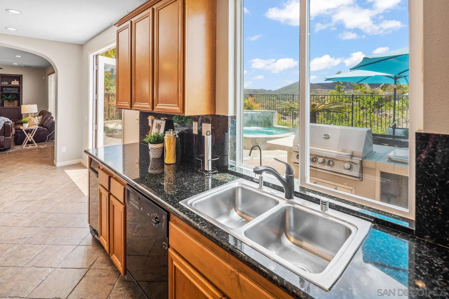 16327 Pinto Ridge Drive 4S Ranch, CA 92127 - Photo 21 of 74 a kitchen sink with granite countertop a coffee maker next to a window