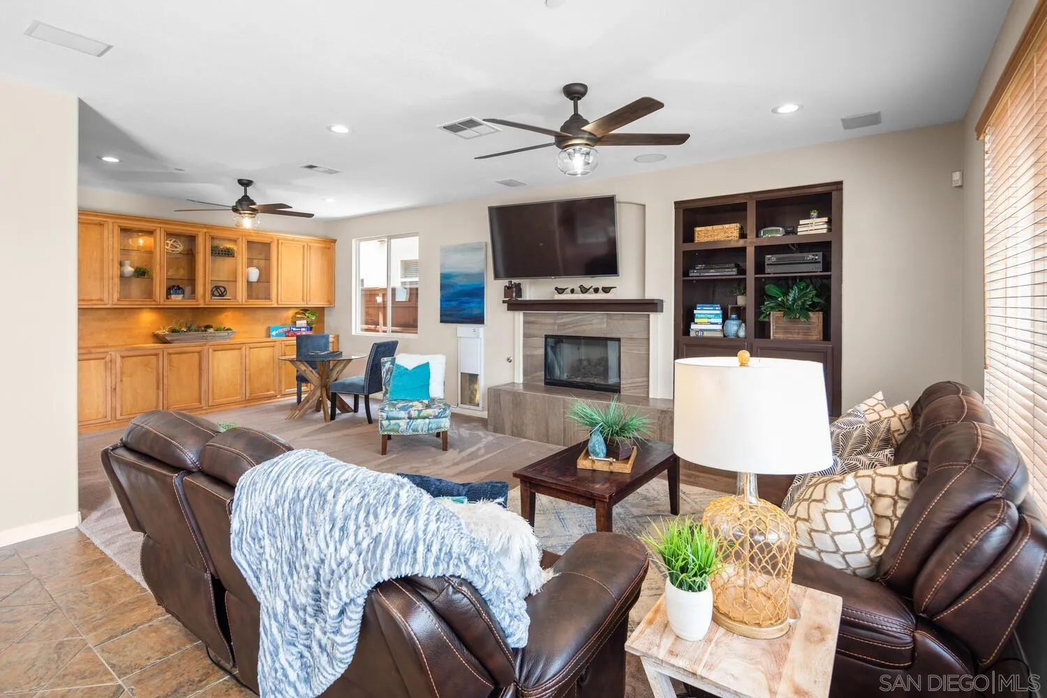 16327 Pinto Ridge Drive 4S Ranch, CA 92127 - Photo 27 of 74 a living room with furniture a fireplace and a flat screen tv