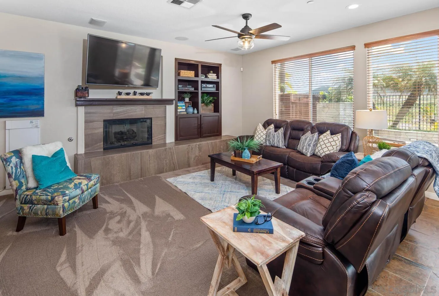 16327 Pinto Ridge Drive 4S Ranch, CA 92127 - Photo 29 of 74 a living room with furniture a flat screen tv and a fireplace