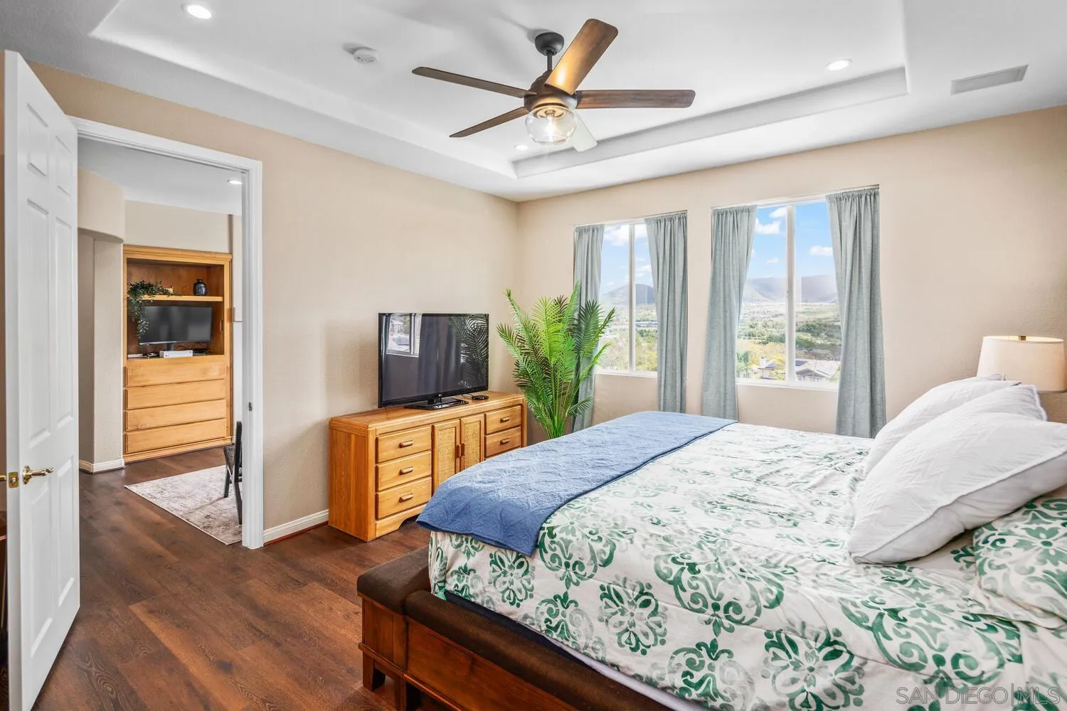 16327 Pinto Ridge Drive 4S Ranch, CA 92127 - Photo 36 of 74 a bedroom with a large bed a chandelier and a dresser