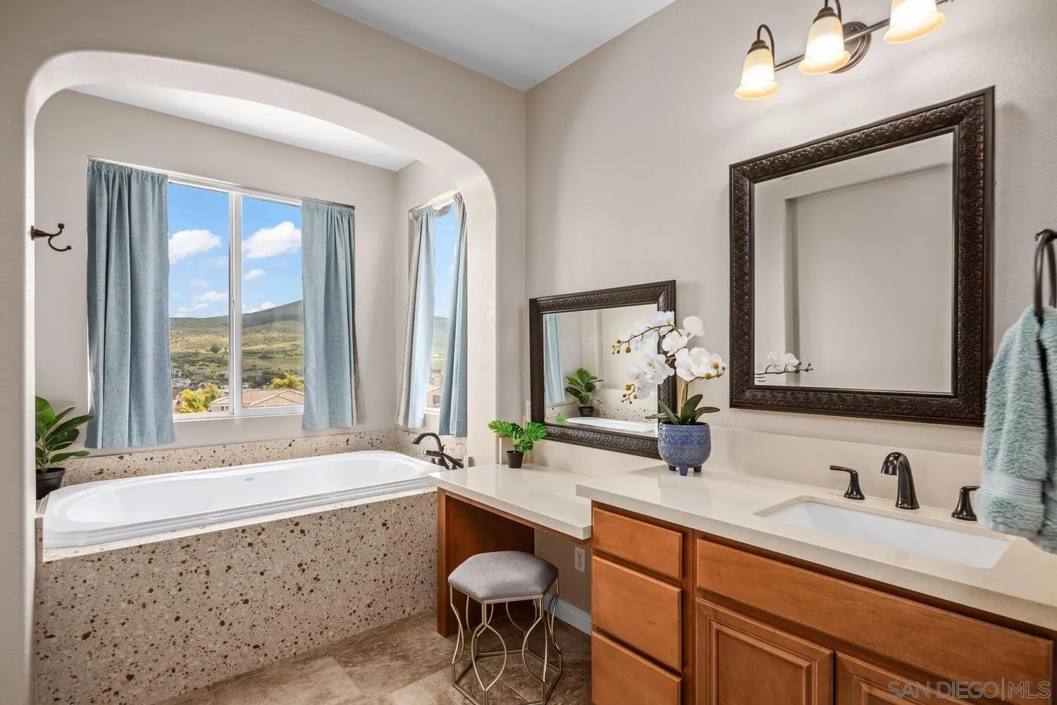 16327 Pinto Ridge Drive 4S Ranch, CA 92127 - Photo 39 of 74 a bathroom with double vanity sinks a large mirror and a bathtub