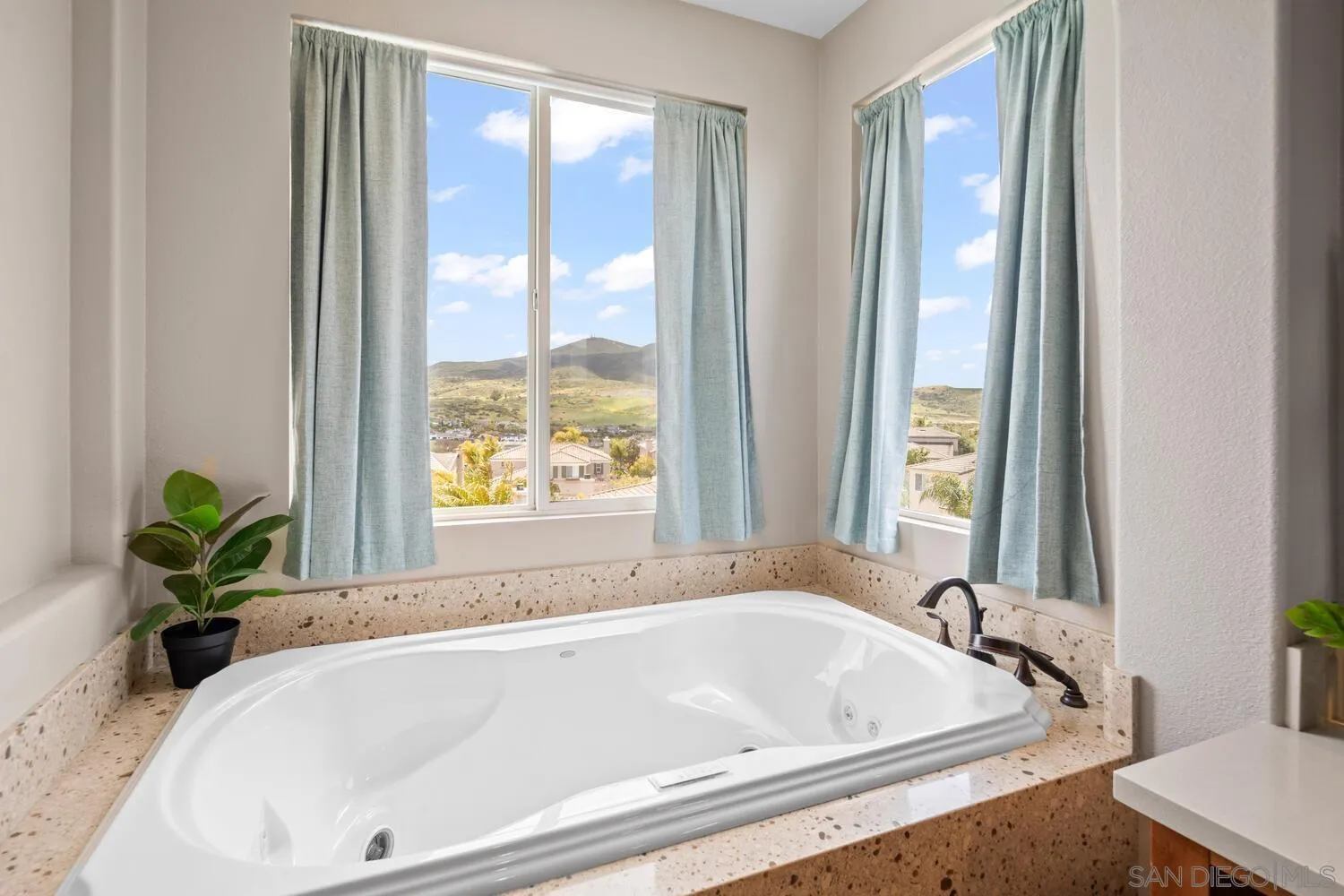 16327 Pinto Ridge Drive 4S Ranch, CA 92127 - Photo 40 of 74 a white bath tub sitting in a bathroom next to a window