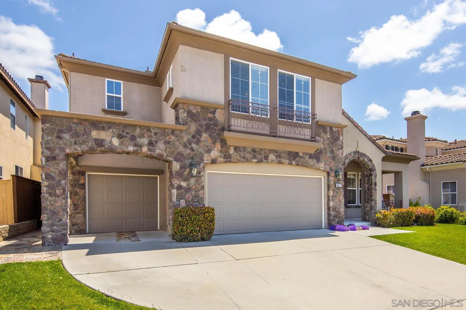 16327 Pinto Ridge Drive 4S Ranch, CA 92127 - Photo 4 of 74 a front view of a house with a yard and garage