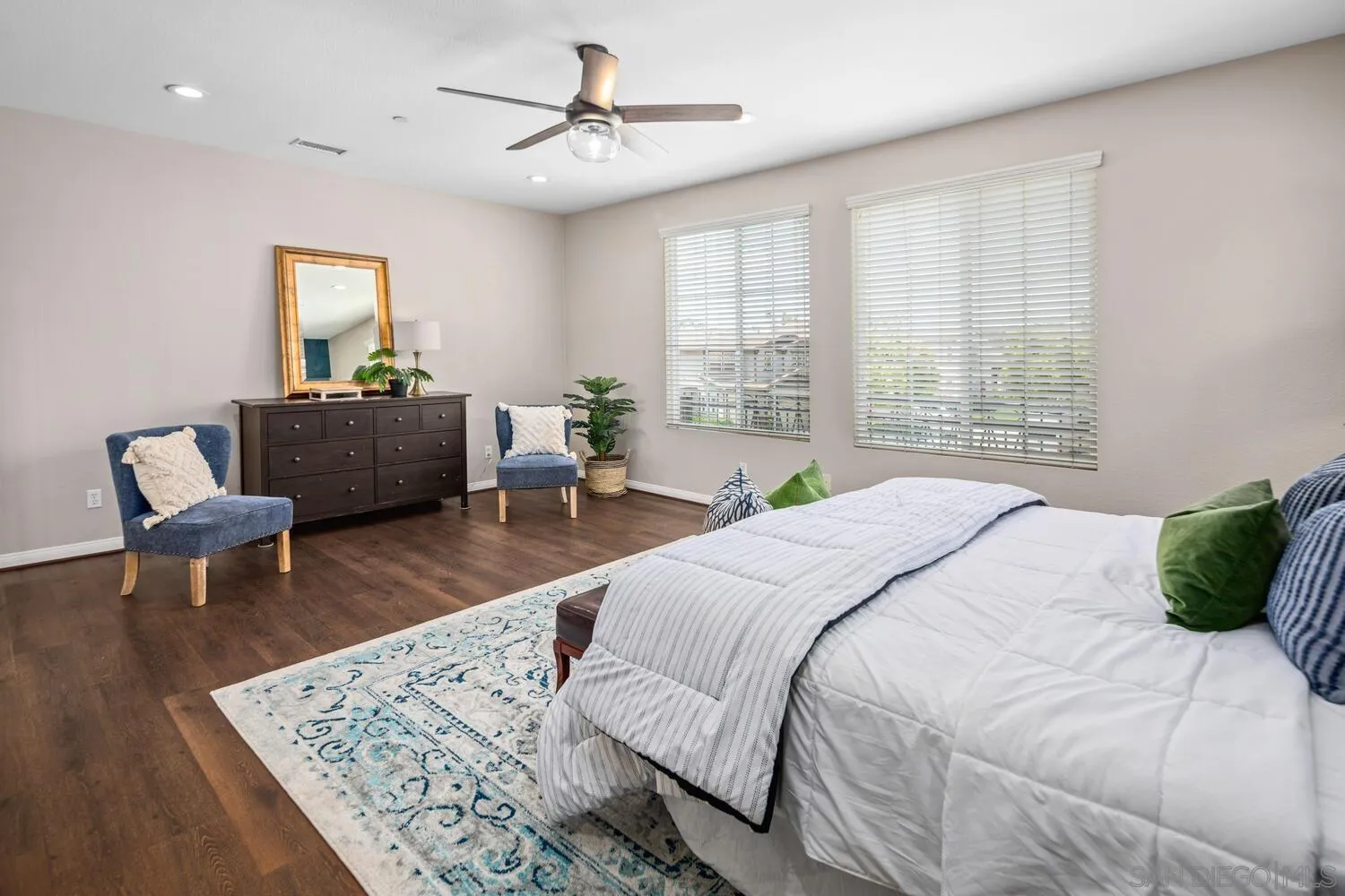 16327 Pinto Ridge Drive 4S Ranch, CA 92127 - Photo 45 of 74 a bedroom with a bed a couch and a window with wooden floor