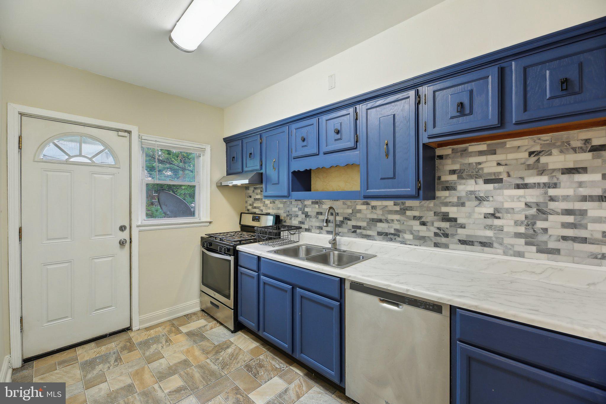 5509 Lothian Road Baltimore, MD 21212 - Photo 12 of 31 a kitchen with a sink and wooden cabinets