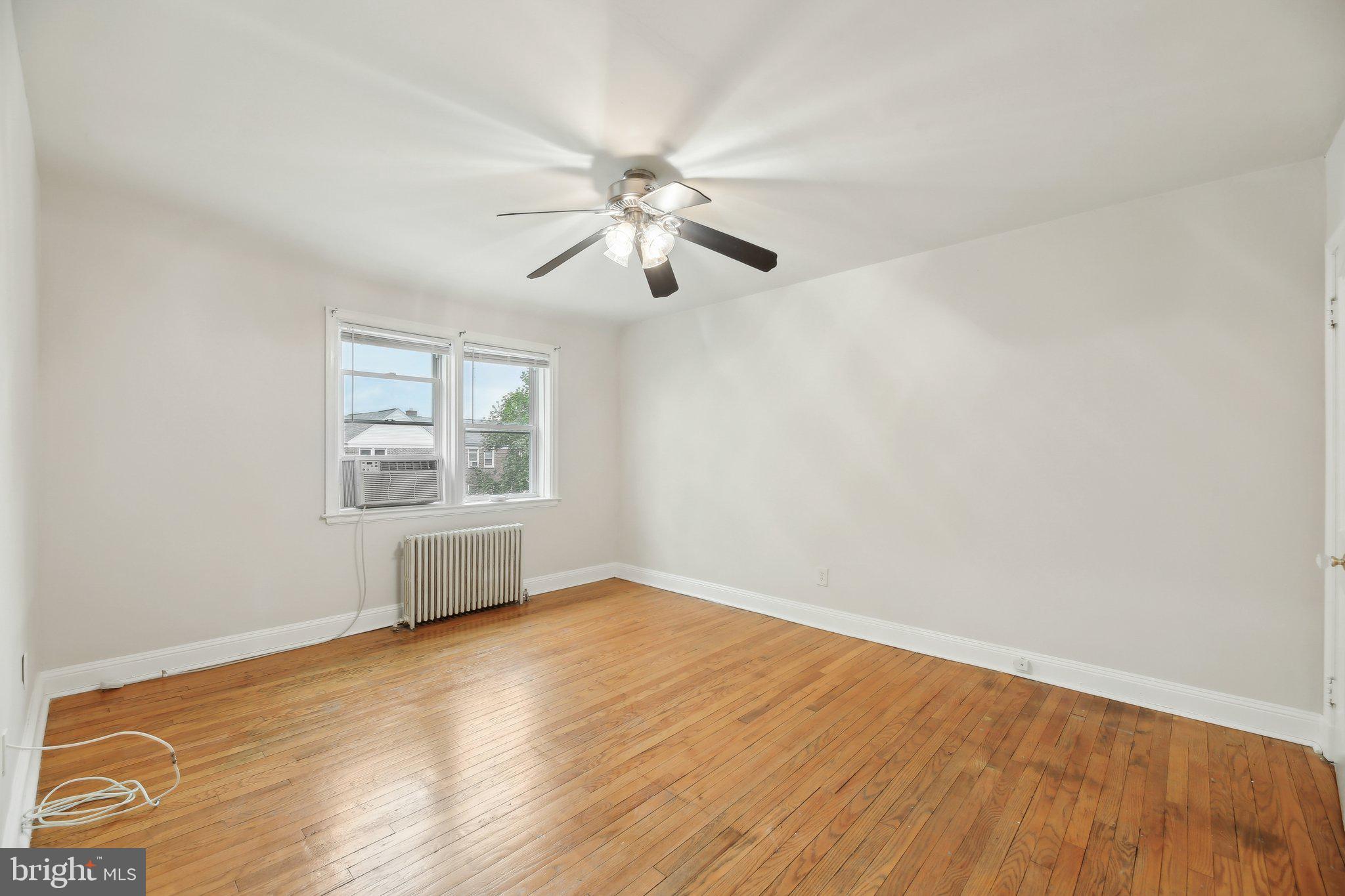 5509 Lothian Road Baltimore, MD 21212 - Photo 15 of 31 wooden floor in an empty room with a window