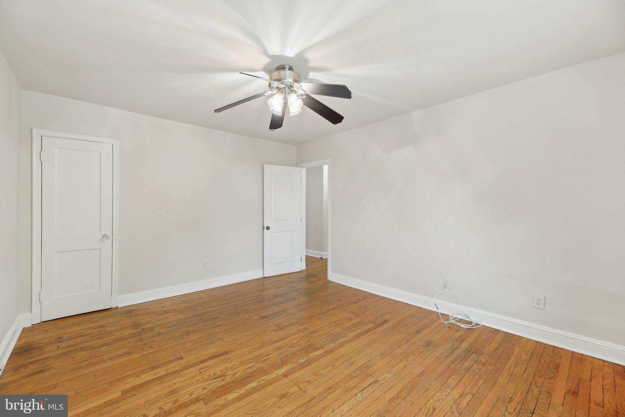 5509 Lothian Road Baltimore, MD 21212 - Photo 17 of 31 an empty room with wooden floor fan and windows