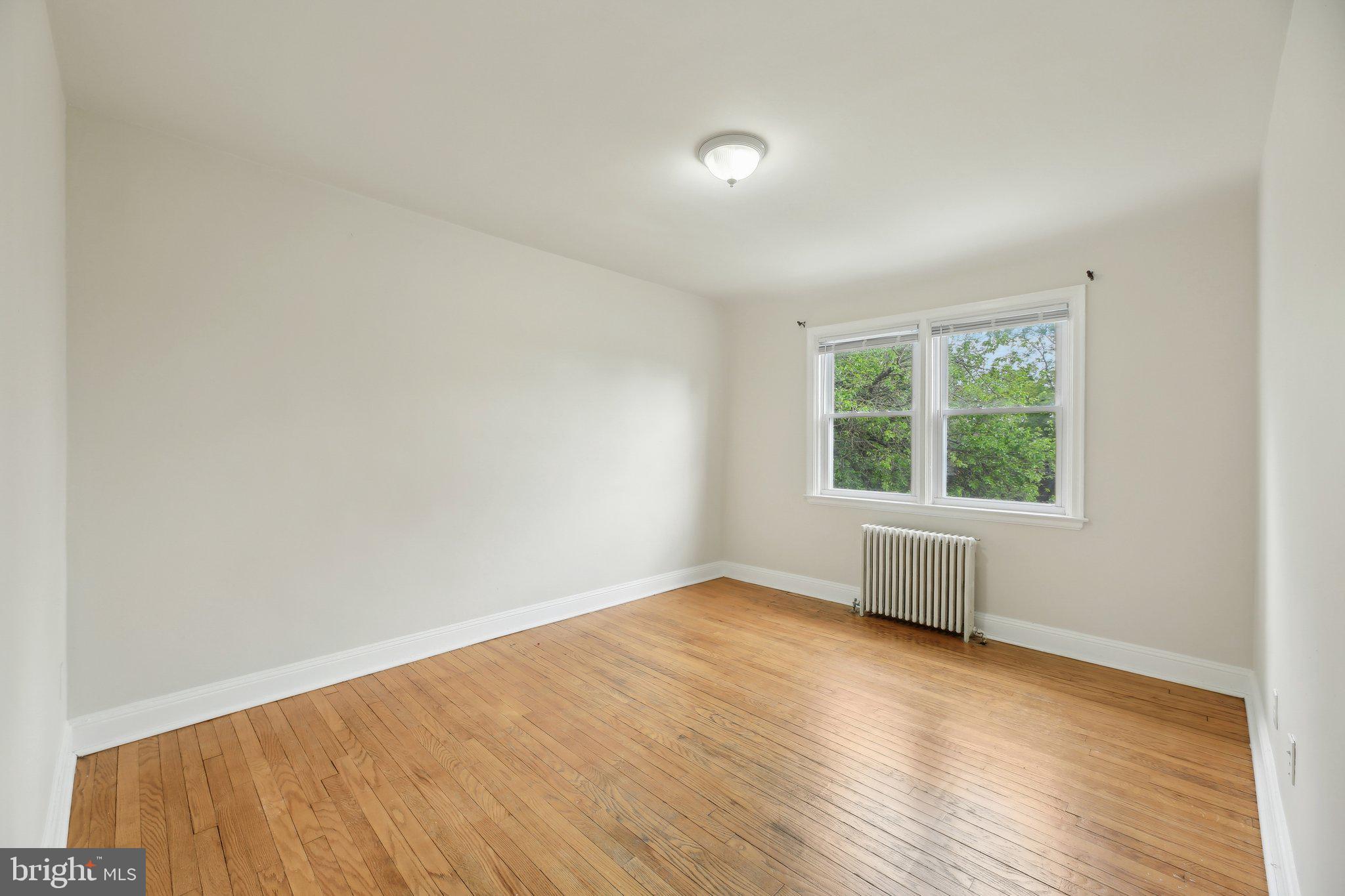 5509 Lothian Road Baltimore, MD 21212 - Photo 18 of 31 an empty room with wooden floor and windows