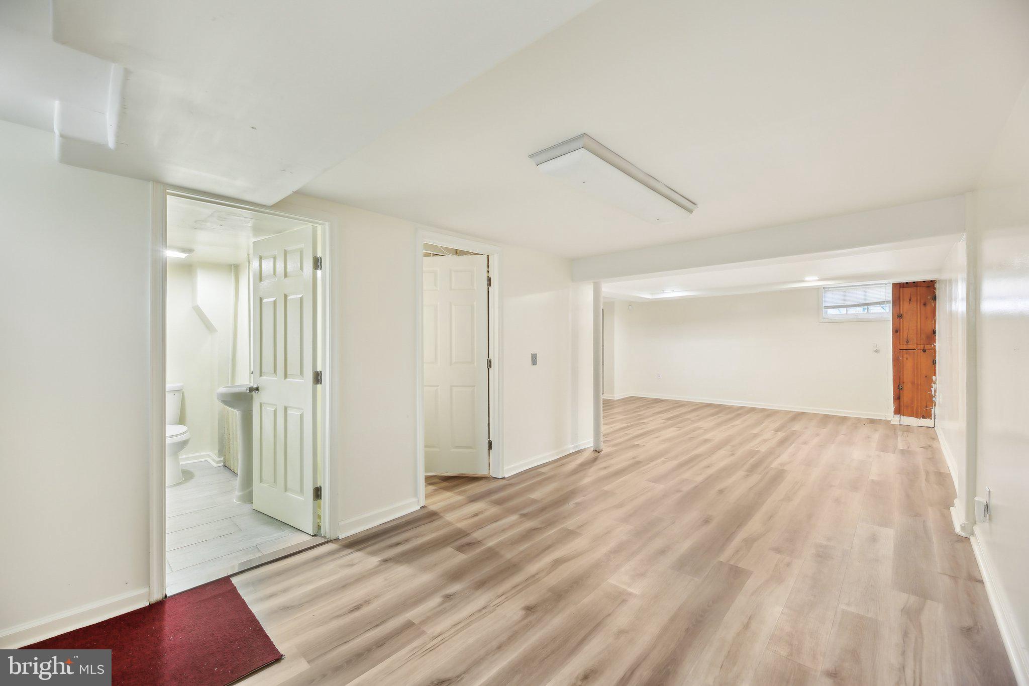 5509 Lothian Road Baltimore, MD 21212 - Photo 24 of 31 a view of empty room with wooden floor and entryway