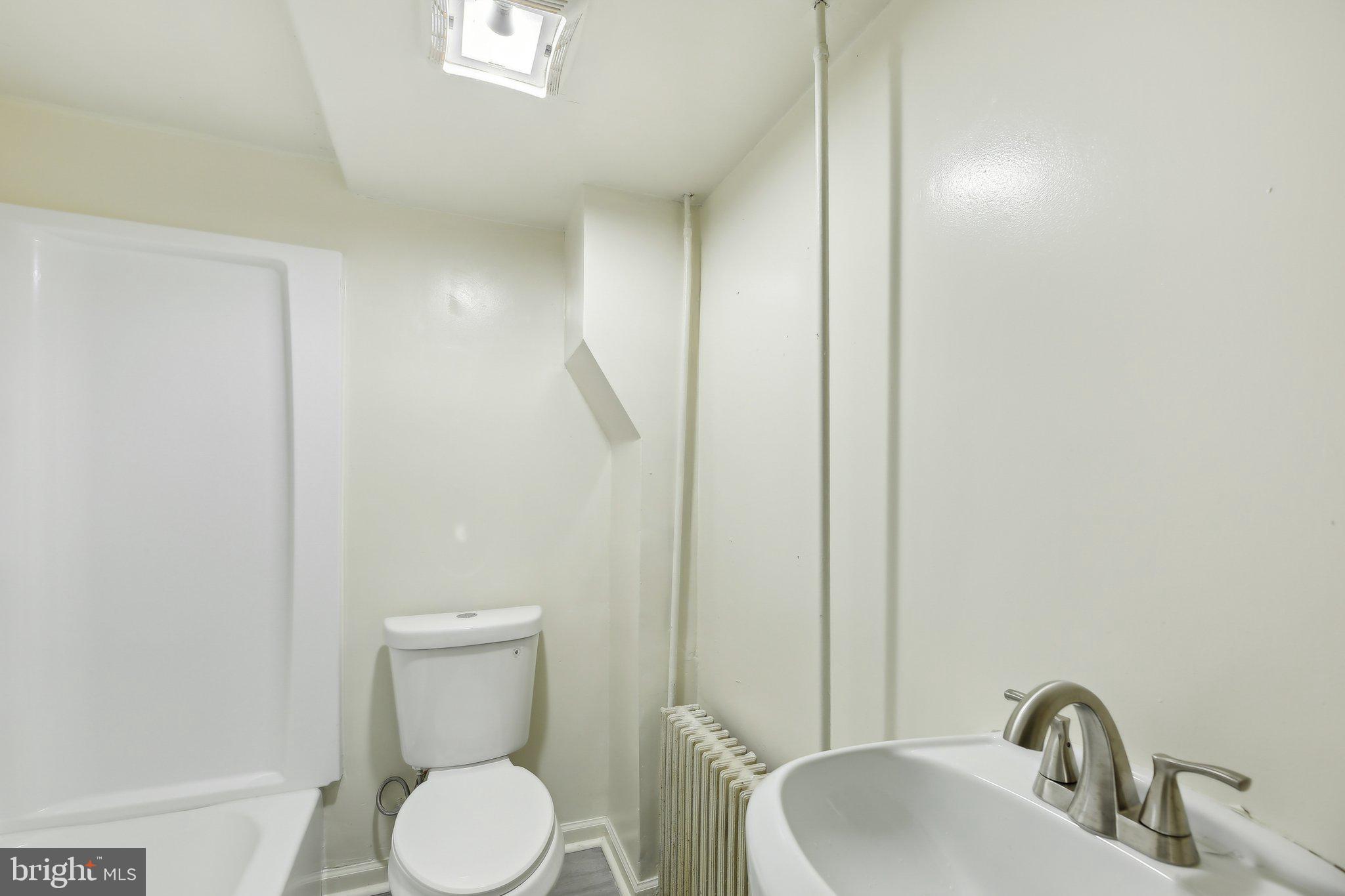 5509 Lothian Road Baltimore, MD 21212 - Photo 25 of 31 a bathroom with a toilet sink and mirror