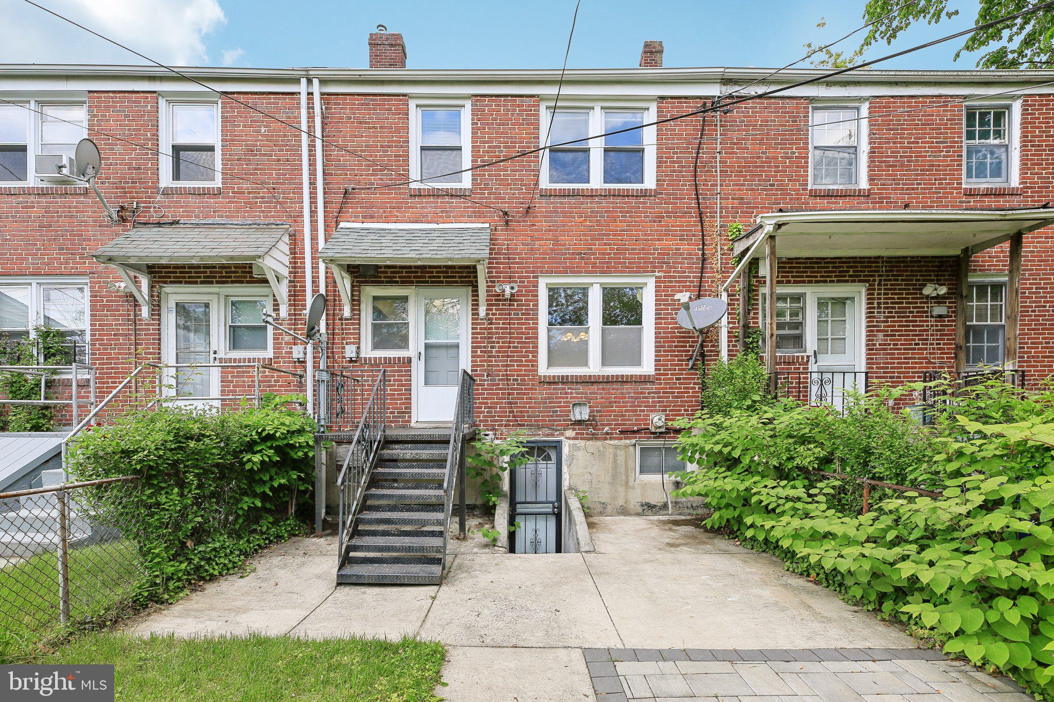 5509 Lothian Road Baltimore, MD 21212 - Photo 28 of 31 a front view of a brick house with a yard