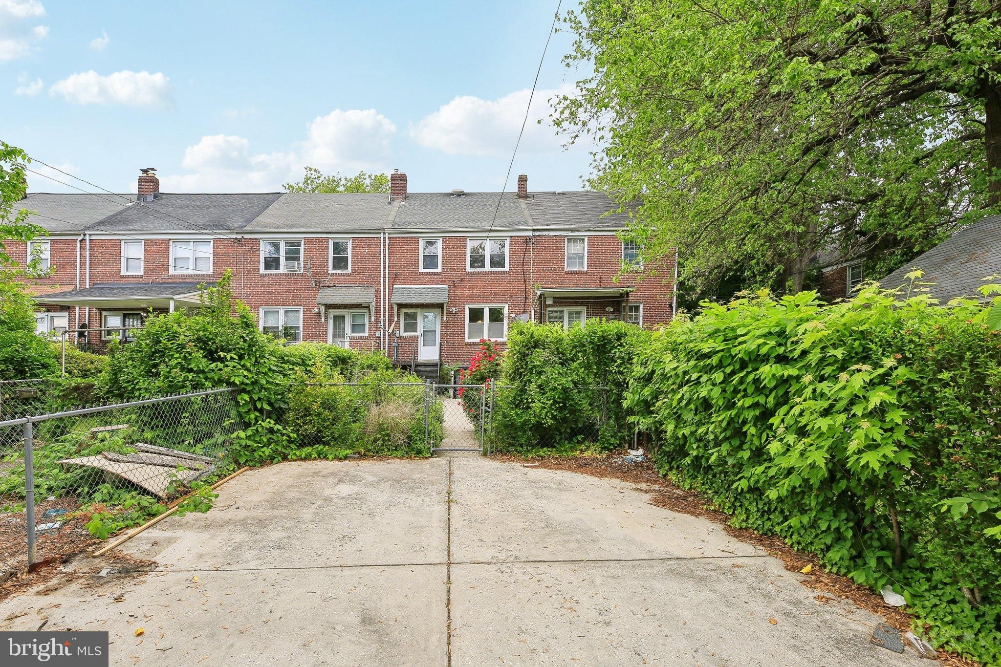 5509 Lothian Road Baltimore, MD 21212 - Photo 29 of 31 a front view of a house with a yard and trees