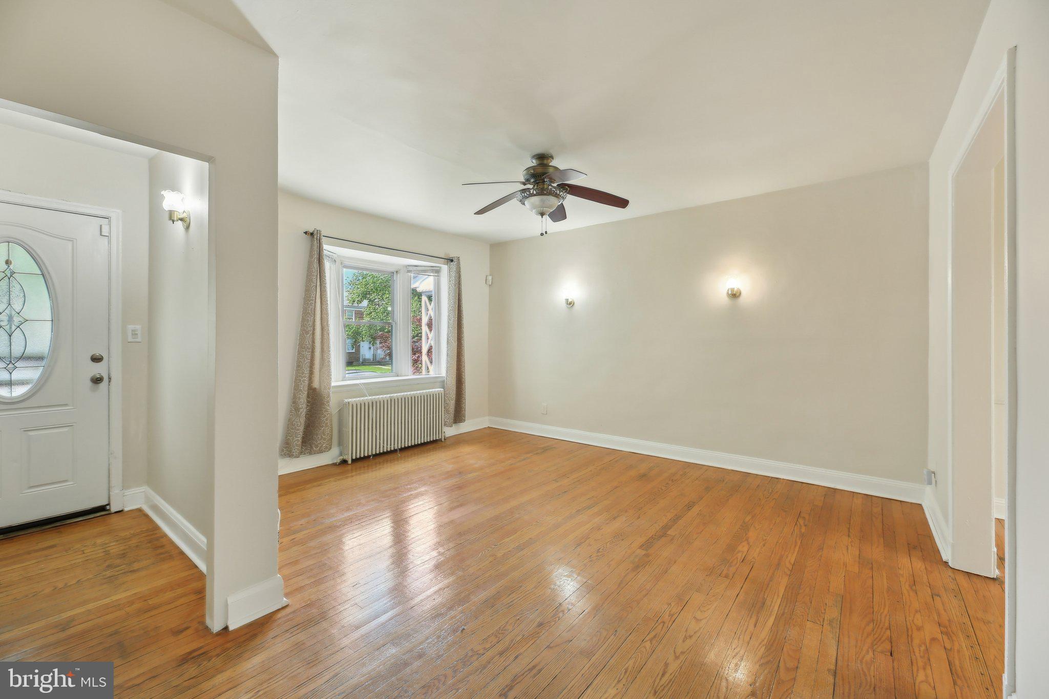 5509 Lothian Road Baltimore, MD 21212 - Photo 6 of 31 wooden floor in an empty room with a window