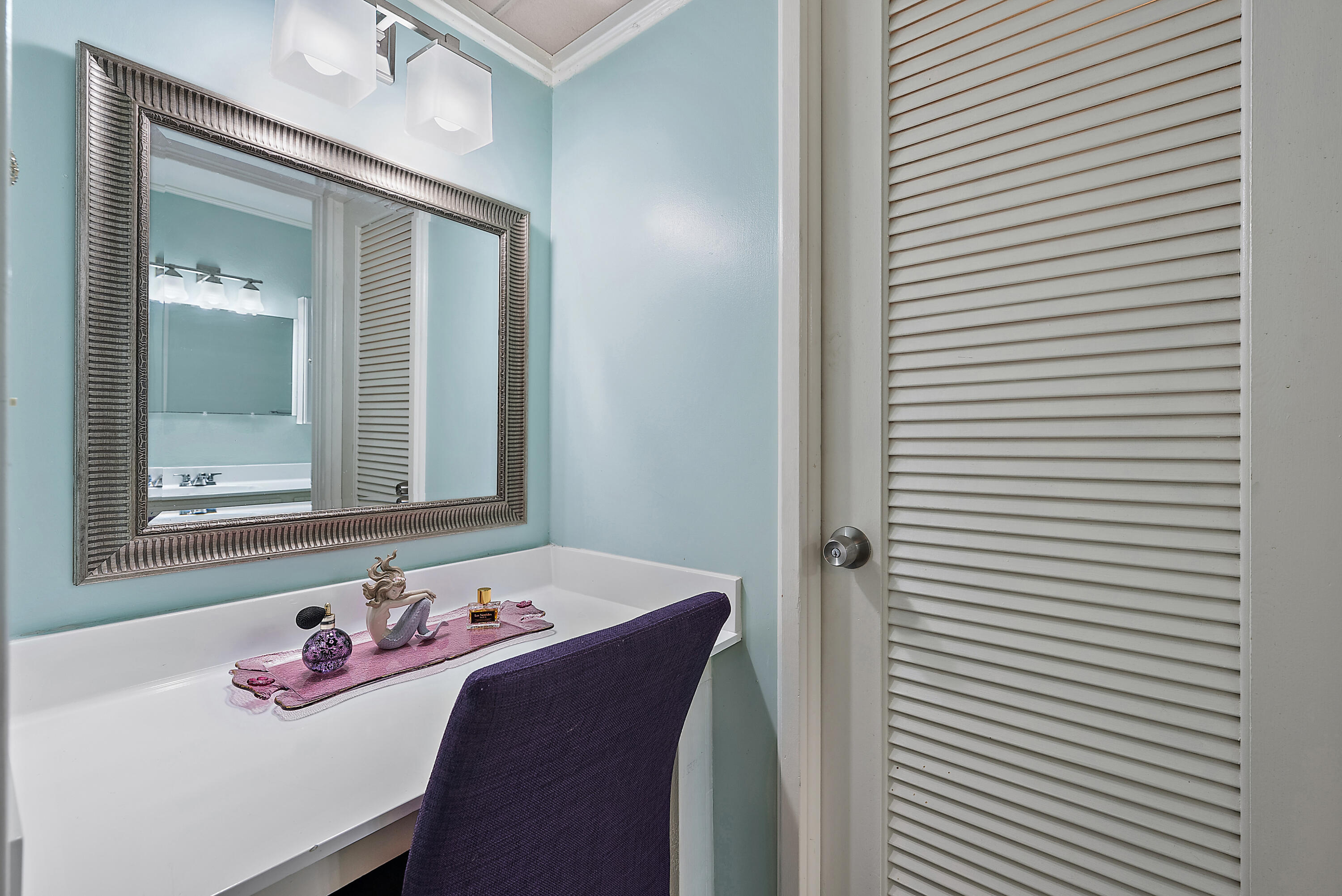 1561 Northeast 12th Terrace, Unit C14 Jensen Beach, FL 34957 - Photo 14 of 27 a bathroom with a sink and a mirror