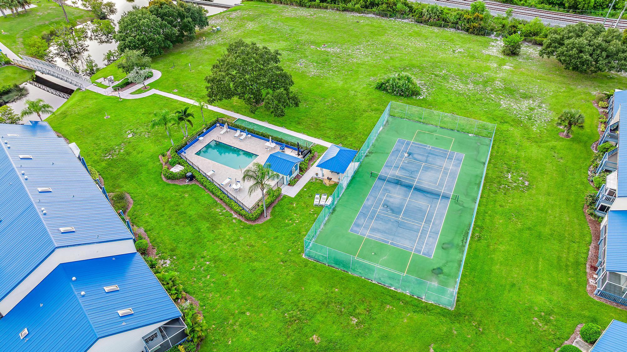 1561 Northeast 12th Terrace, Unit C14 Jensen Beach, FL 34957 - Photo 23 of 27 an aerial view of a yard