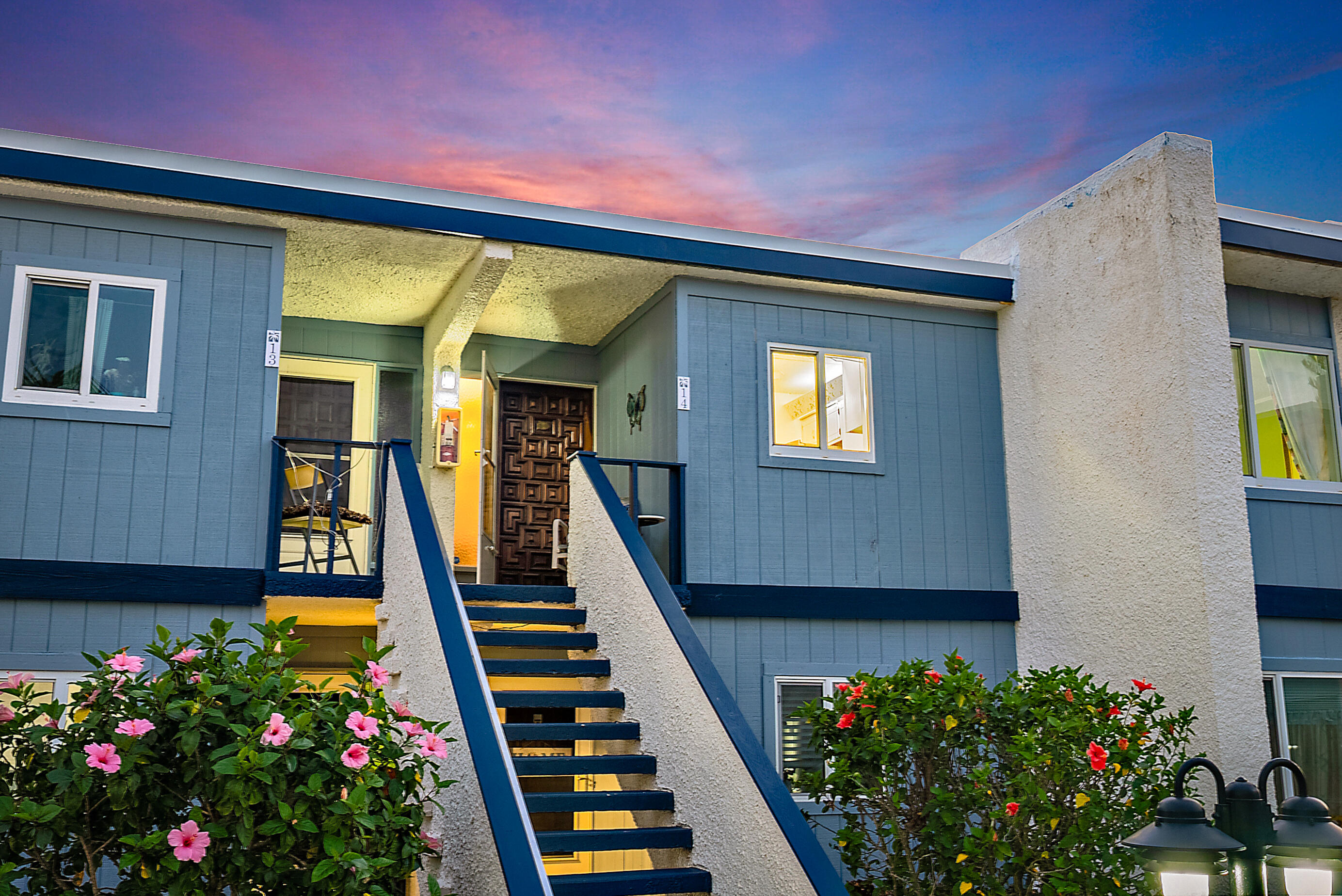 1561 Northeast 12th Terrace, Unit C14 Jensen Beach, FL 34957 - Photo 4 of 27 a front view of house with yard