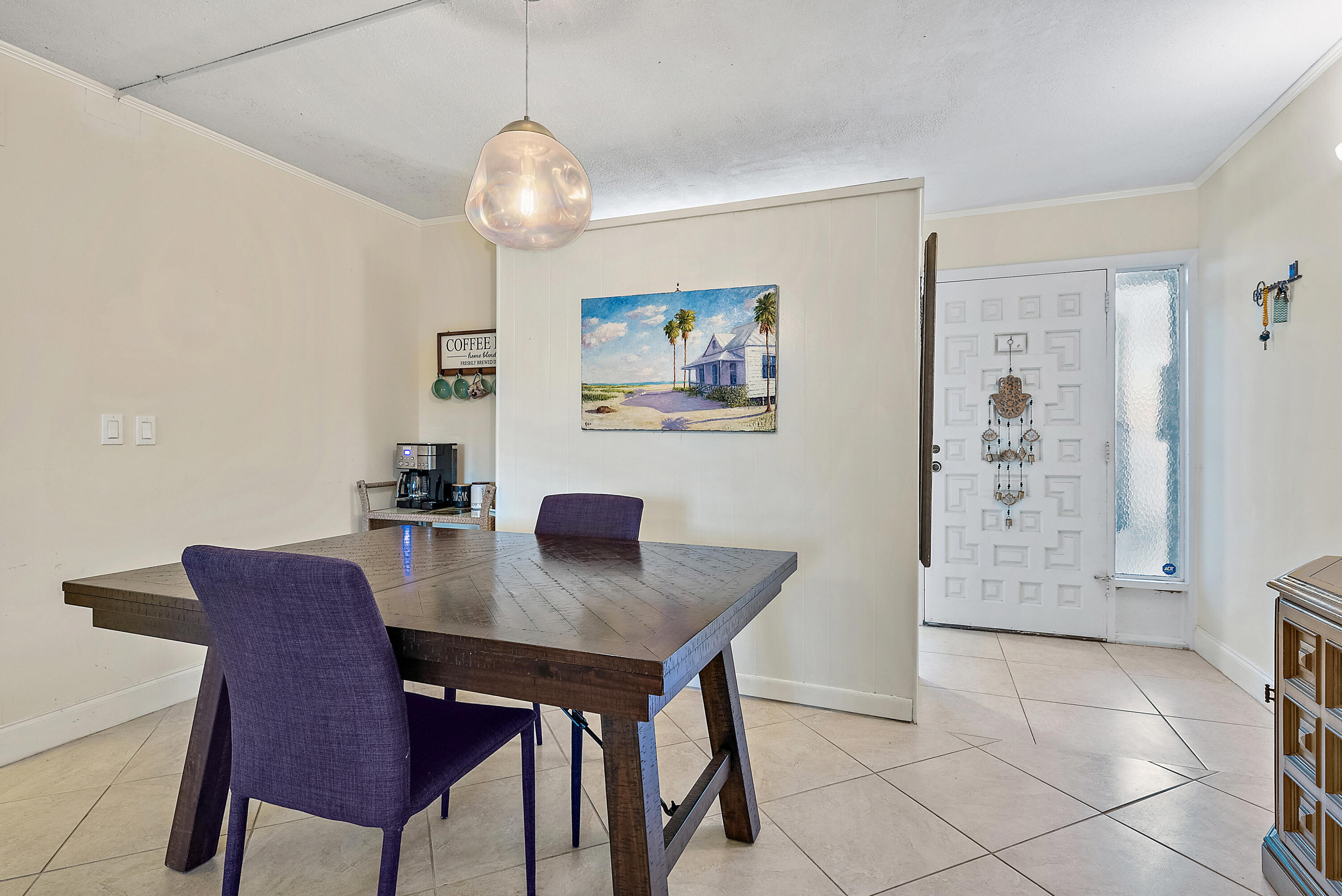 1561 Northeast 12th Terrace, Unit C14 Jensen Beach, FL 34957 - Photo 6 of 27 a view of a dining room with furniture