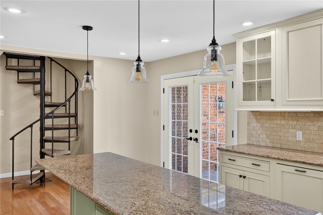 1371 Stoke Park Road Bethlehem, PA 18017 - Photo 24 of 55 a kitchen with stainless steel appliances granite countertop a refrigerator a oven and white cabinets with wooden floor