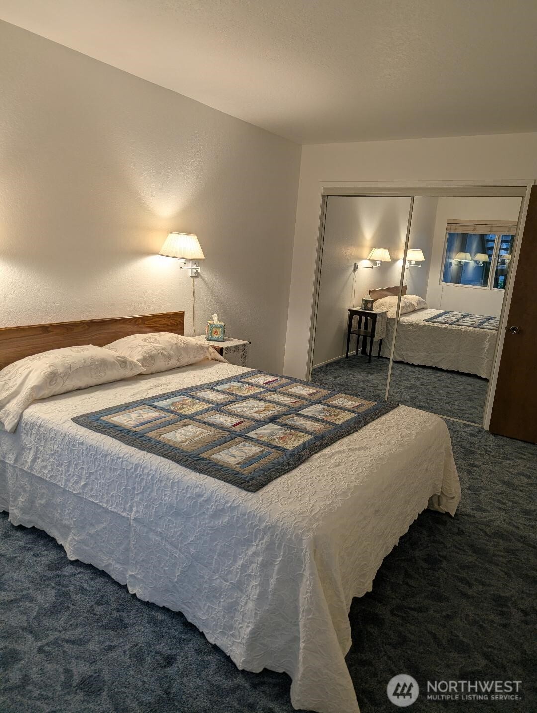 2001 Skyline Way, Unit 103 Anacortes, WA 98221 - Photo 12 of 39 a bedroom with a bed and a lamp