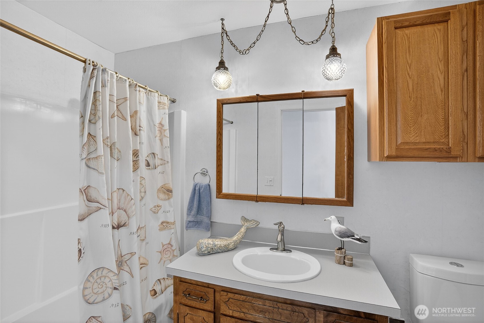 2001 Skyline Way, Unit 103 Anacortes, WA 98221 - Photo 13 of 39 a bathroom with a sink a mirror and a shower curtain