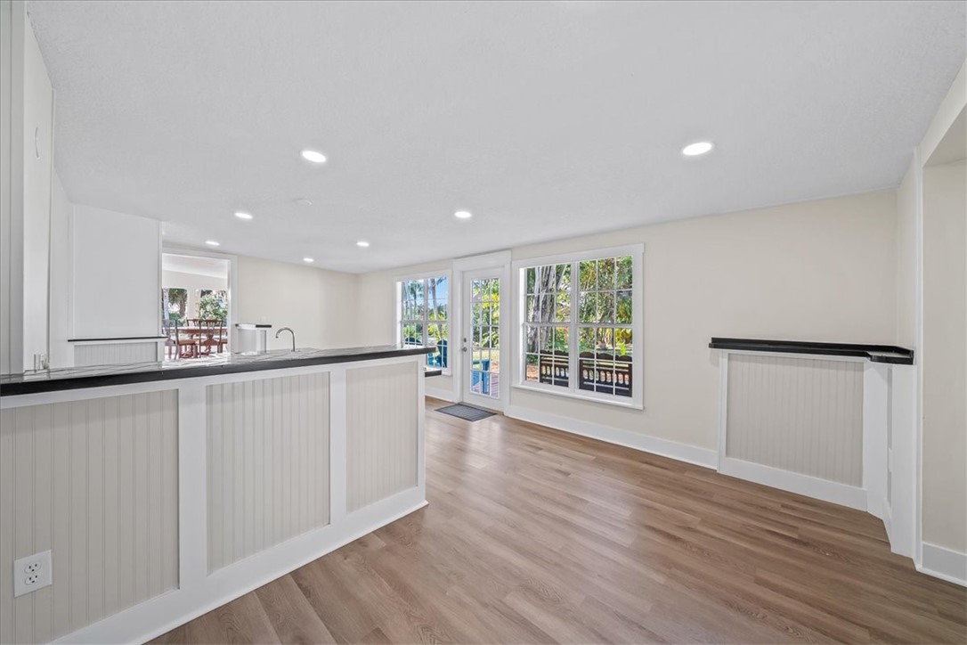 9670 Mockingbird Lane Sebastian, FL 32976 - Photo 12 of 36 a view of an empty room with wooden floor and a window
