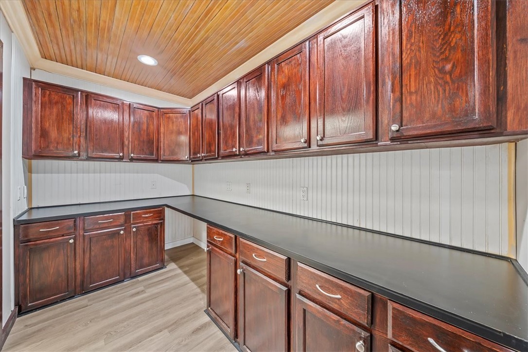 9670 Mockingbird Lane Sebastian, FL 32976 - Photo 22 of 36 a kitchen with stainless steel appliances granite countertop wooden cabinets a sink and dishwasher a refrigerator with wooden cabinets