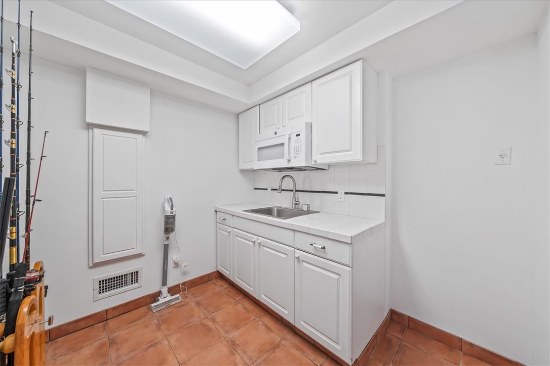 9670 Mockingbird Lane Sebastian, FL 32976 - Photo 24 of 36 a utility room with cabinets washer and dryer