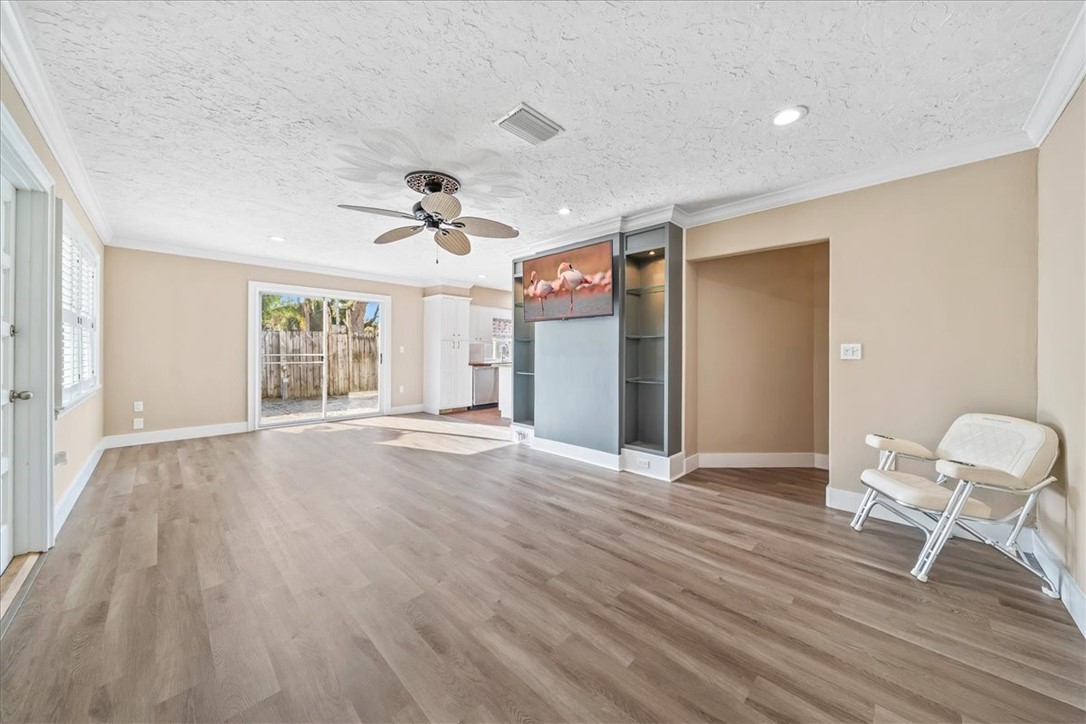9670 Mockingbird Lane Sebastian, FL 32976 - Photo 4 of 36 a view of an empty room with a window and wooden floor