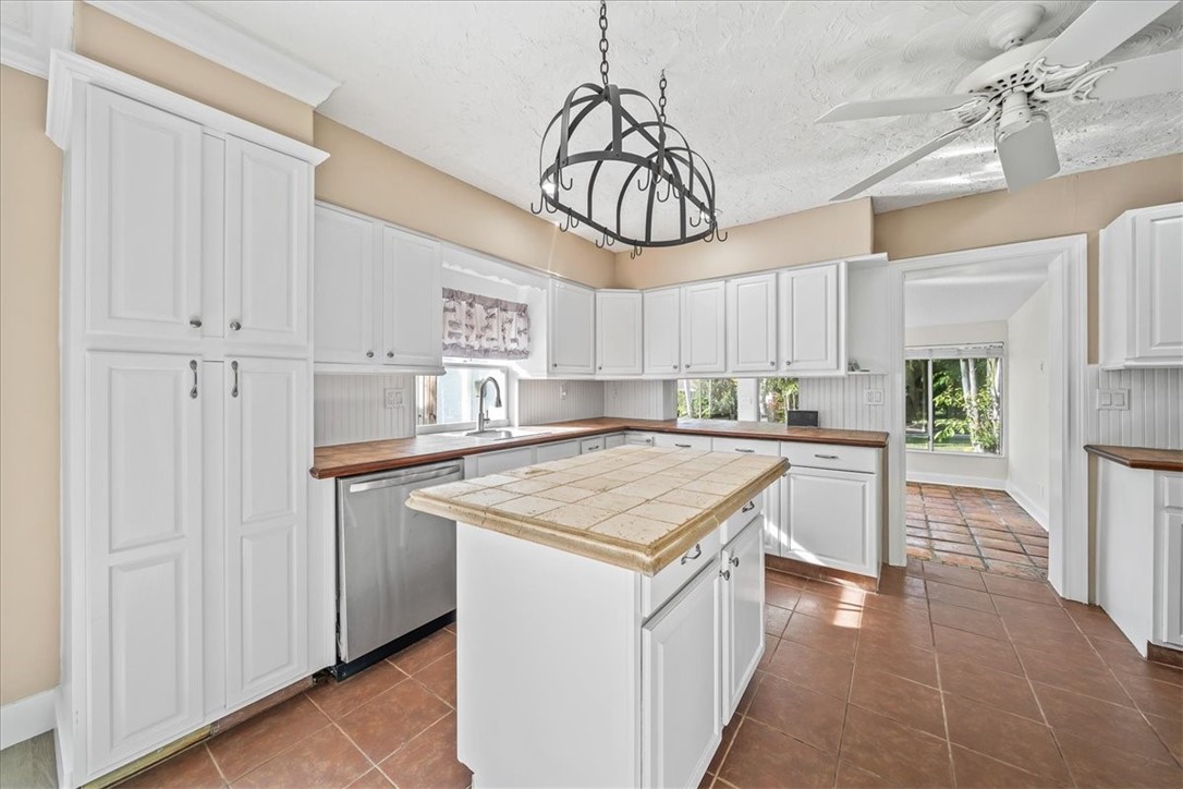 9670 Mockingbird Lane Sebastian, FL 32976 - Photo 5 of 36 a kitchen with kitchen island granite countertop a sink a counter top space and cabinets