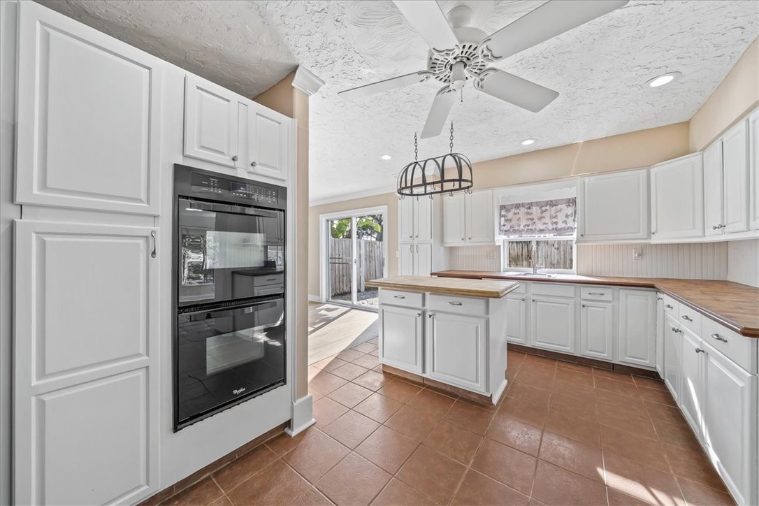 9670 Mockingbird Lane Sebastian, FL 32976 - Photo 6 of 36 a kitchen with cabinets and stainless steel appliances
