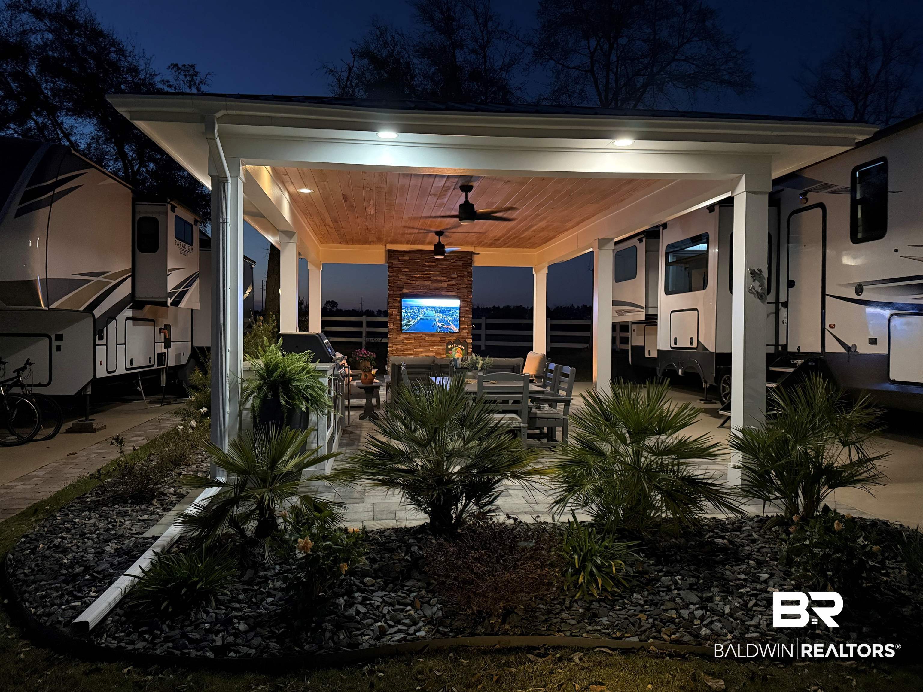 12377 Gateway Drive Elberta, AL 36530 - Photo 28 of 64 Patio at night featuring ceiling fan, a patio, and outdoor dining area