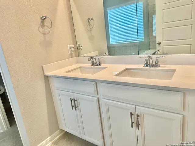 a bathroom with a sink and a mirror
