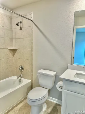 a white toilet sitting next to a bath tub