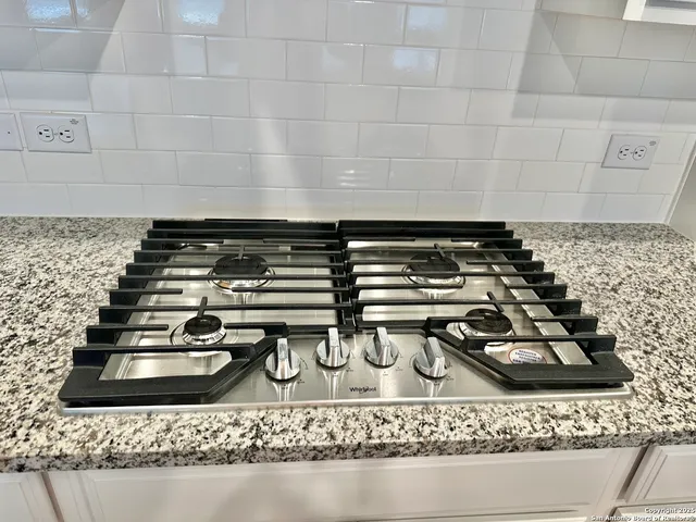 a close view of a stove a faucet and a sink