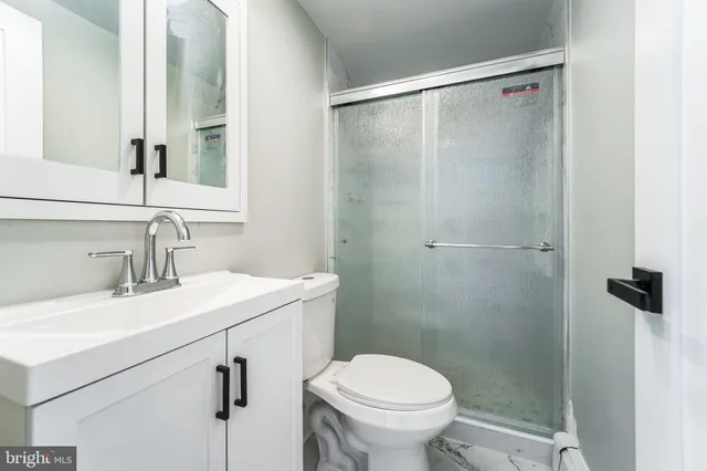 a bathroom with a sink toilet and shower